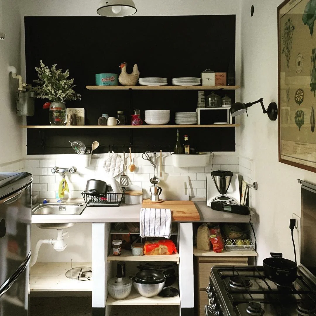 Frame Open Shelving with a Black Chalkboard Wall for a Dramatic Display