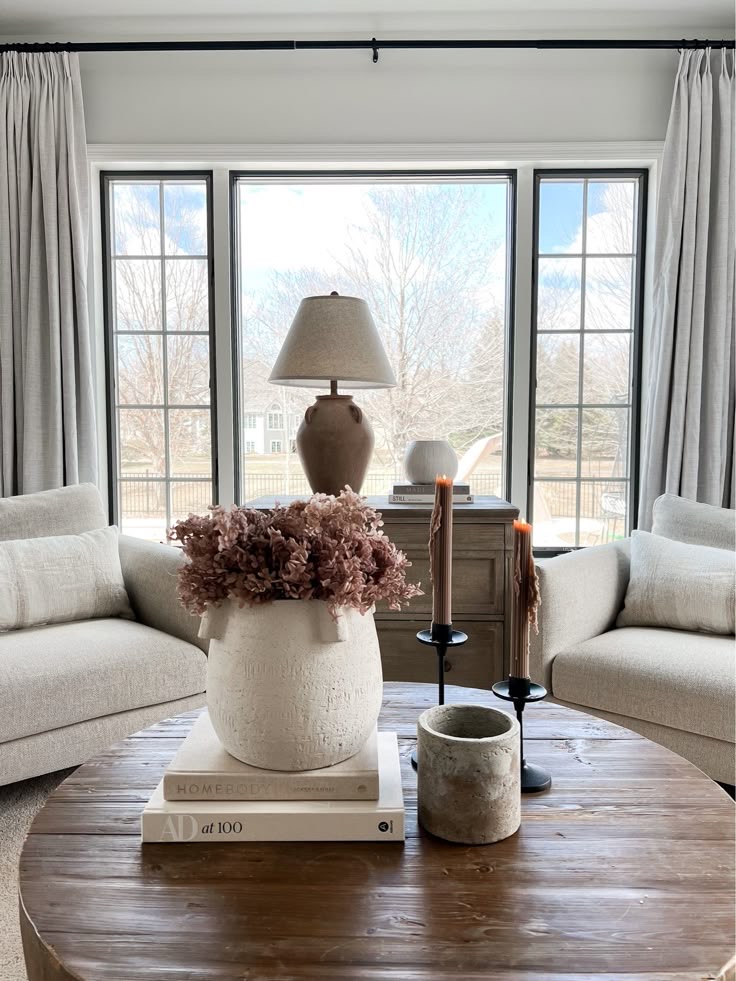 Textured White Vase Holds Dried Flowers and Books