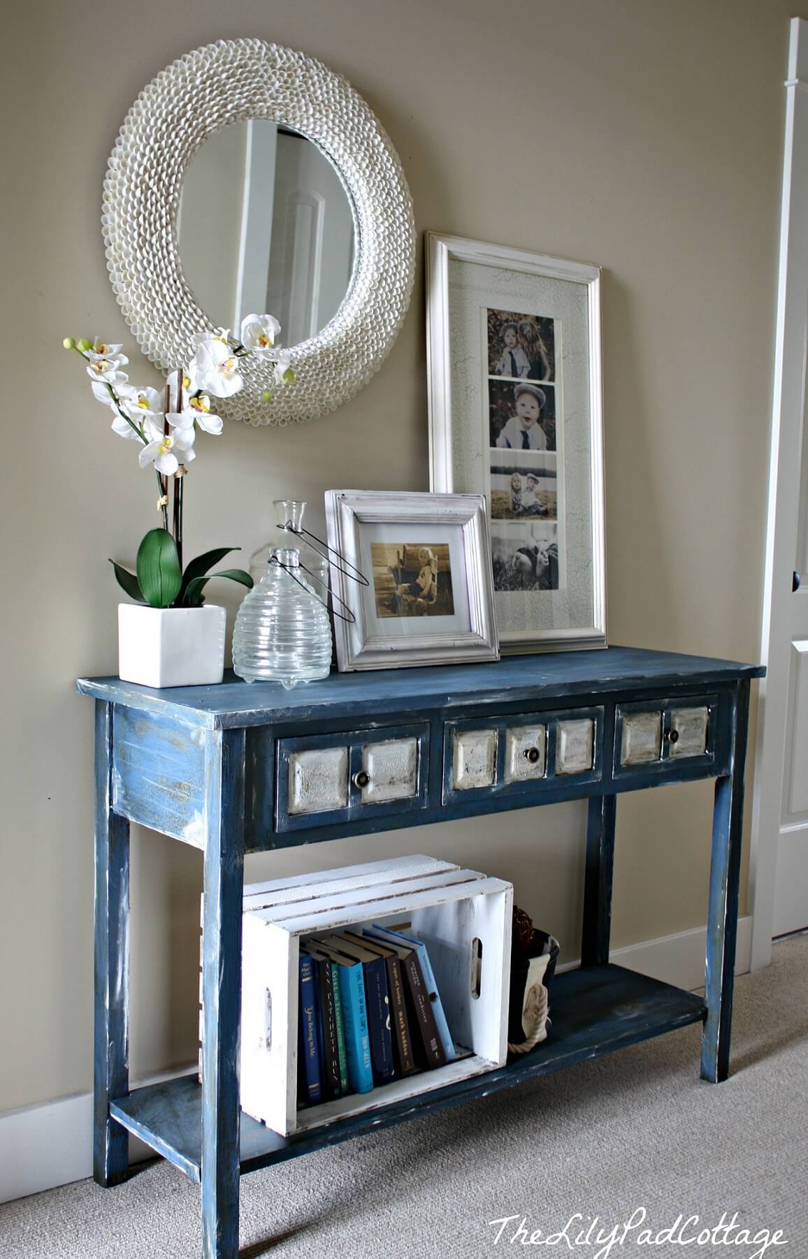 White Crate Organizes Books on Distressed Blue Console