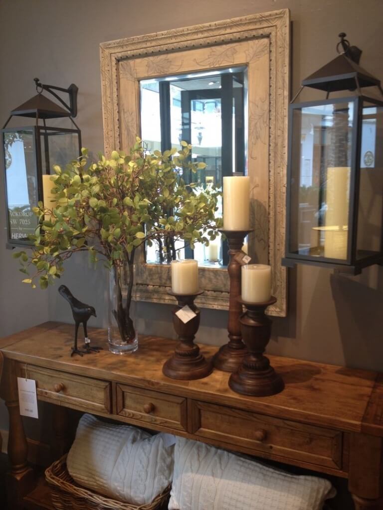 Wooden Candlesticks Anchor a Trio of Creamy Pillar Candles