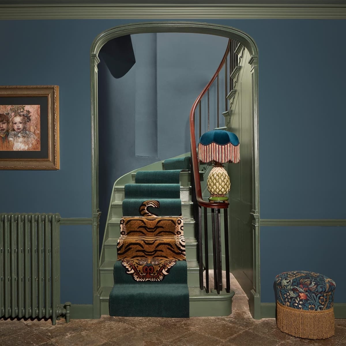 Deep Teal Hallway Walls Frame a Curved Staircase