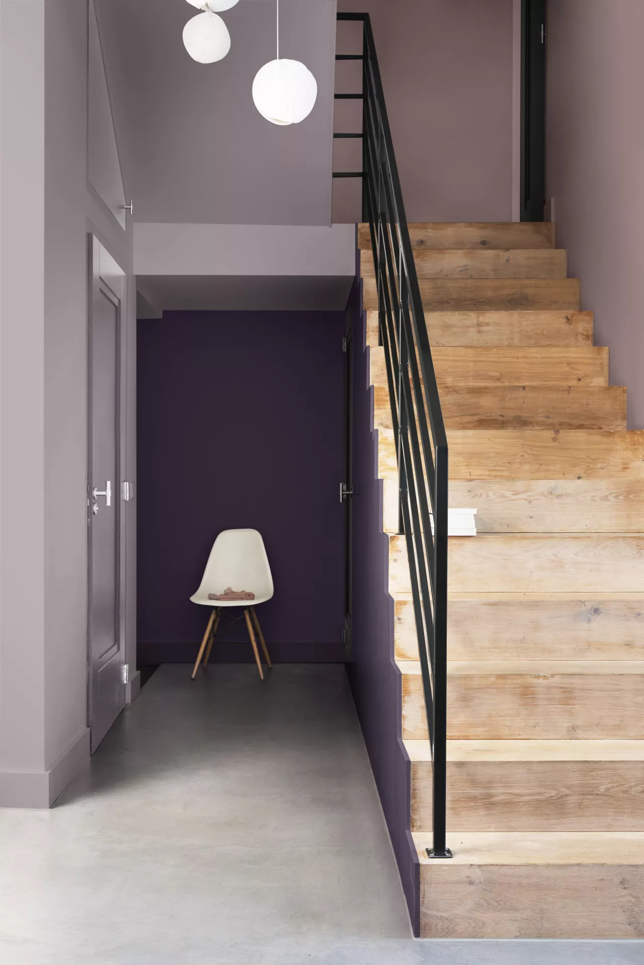 Deep Plum Wall Creates a Bold Backdrop for a White Eames Chair