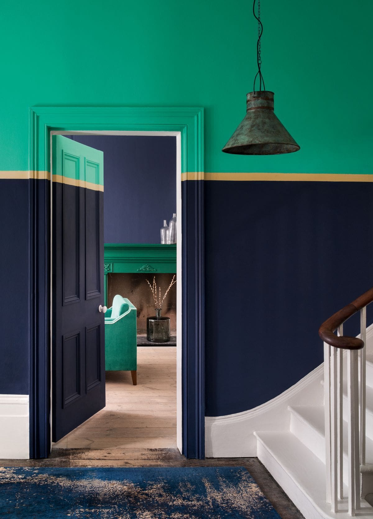 Bold Green and Navy Walls Divided by a Thin Gold Stripe