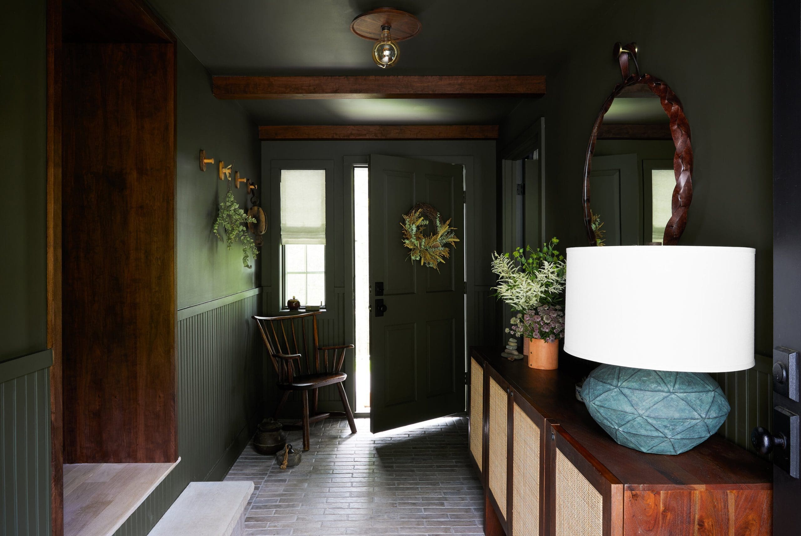 Dark Green Walls Create a Moody Entryway Backdrop
