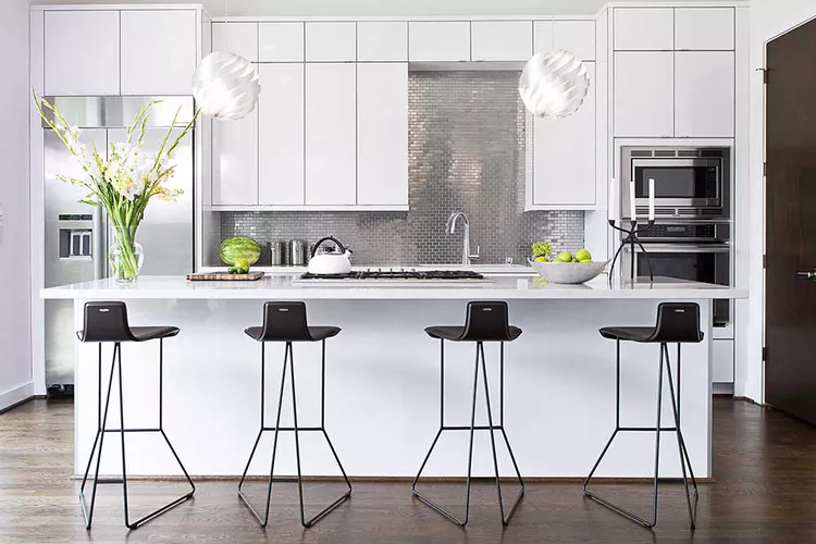 Metallic Mosaic Backsplash Reflects Light Behind White Cabinets