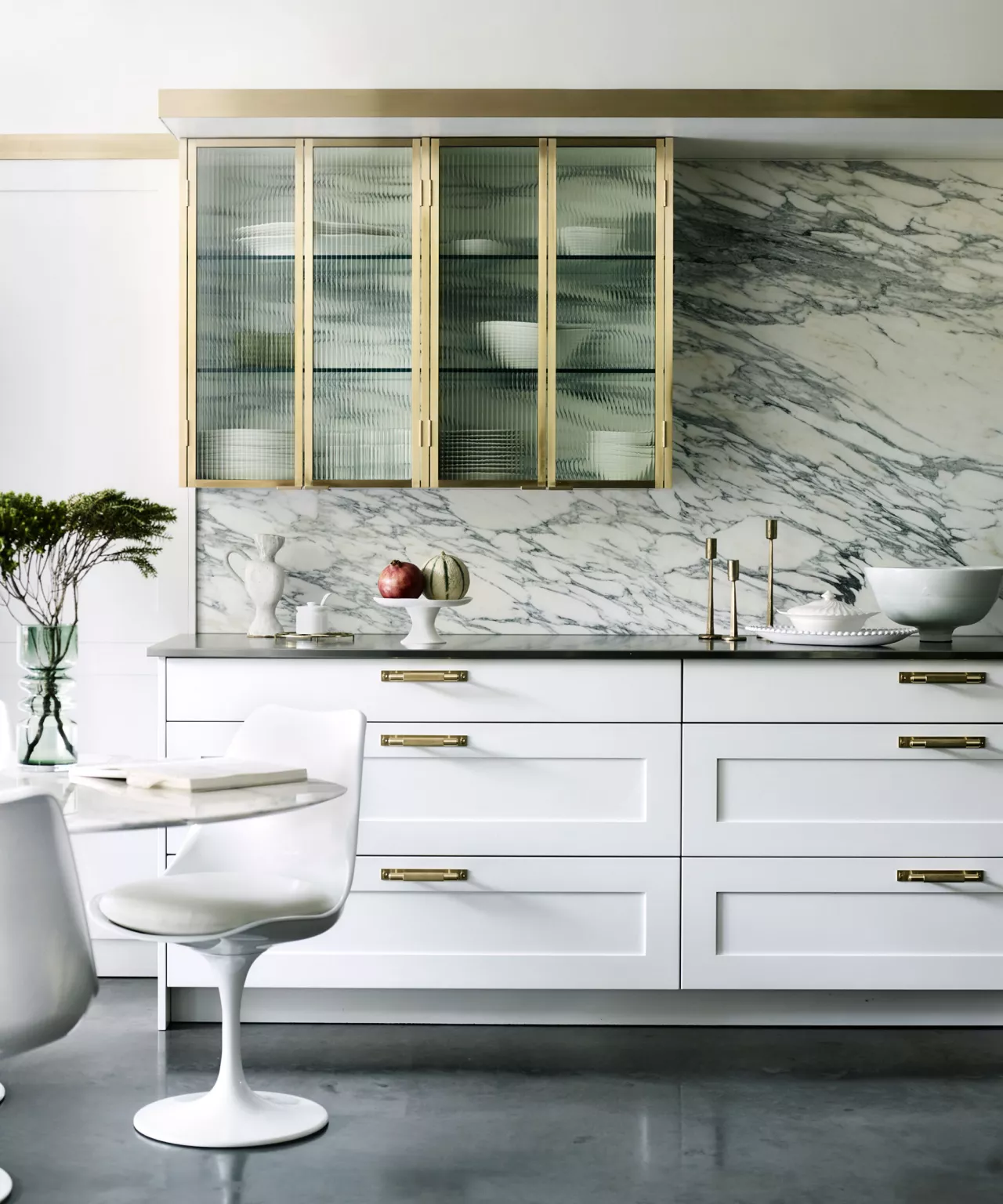 Fluted Glass Cabinet Doors Add Textured Interest Above Marble