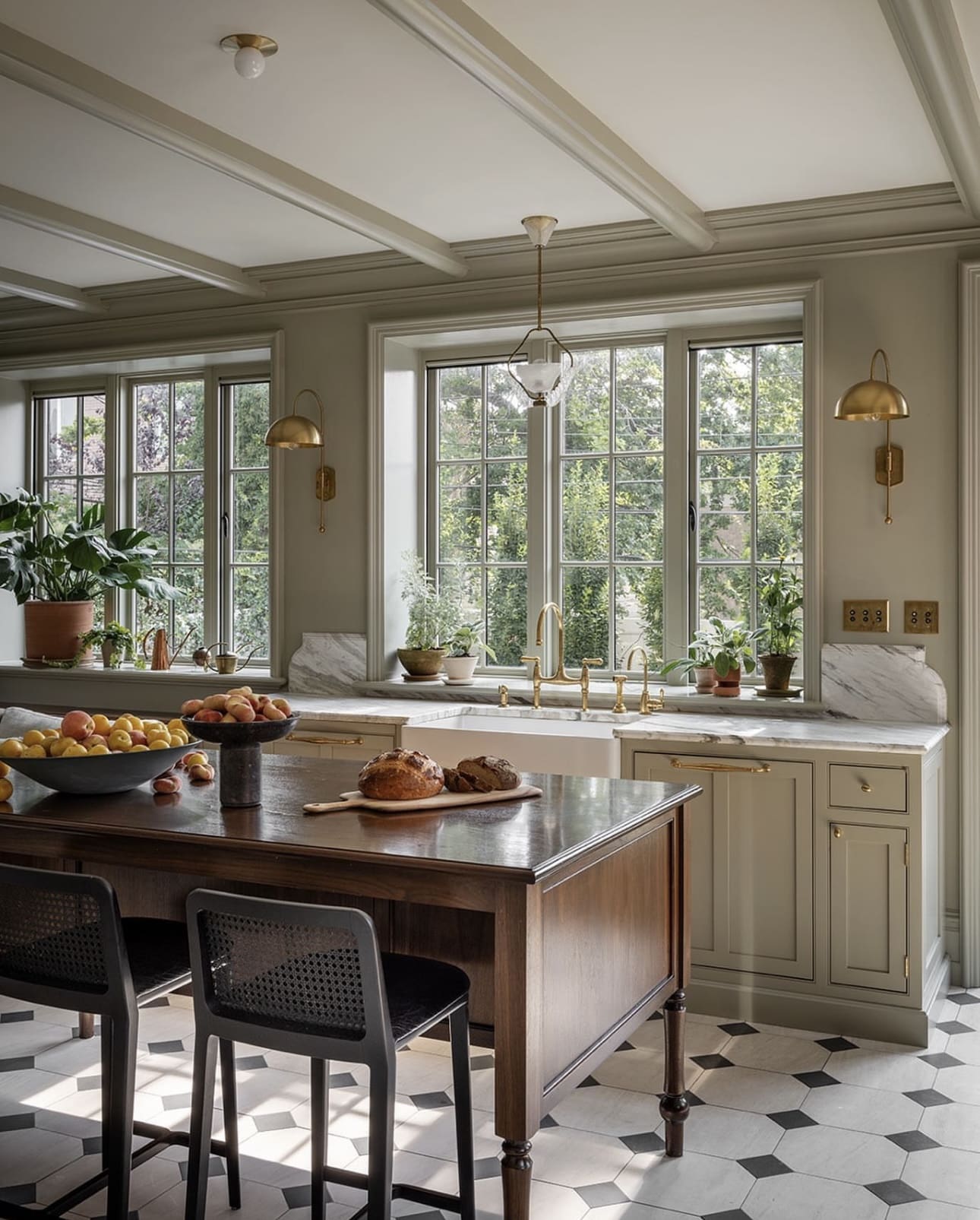 Brass Wall Sconces Add Warm Task Lighting Over Windows