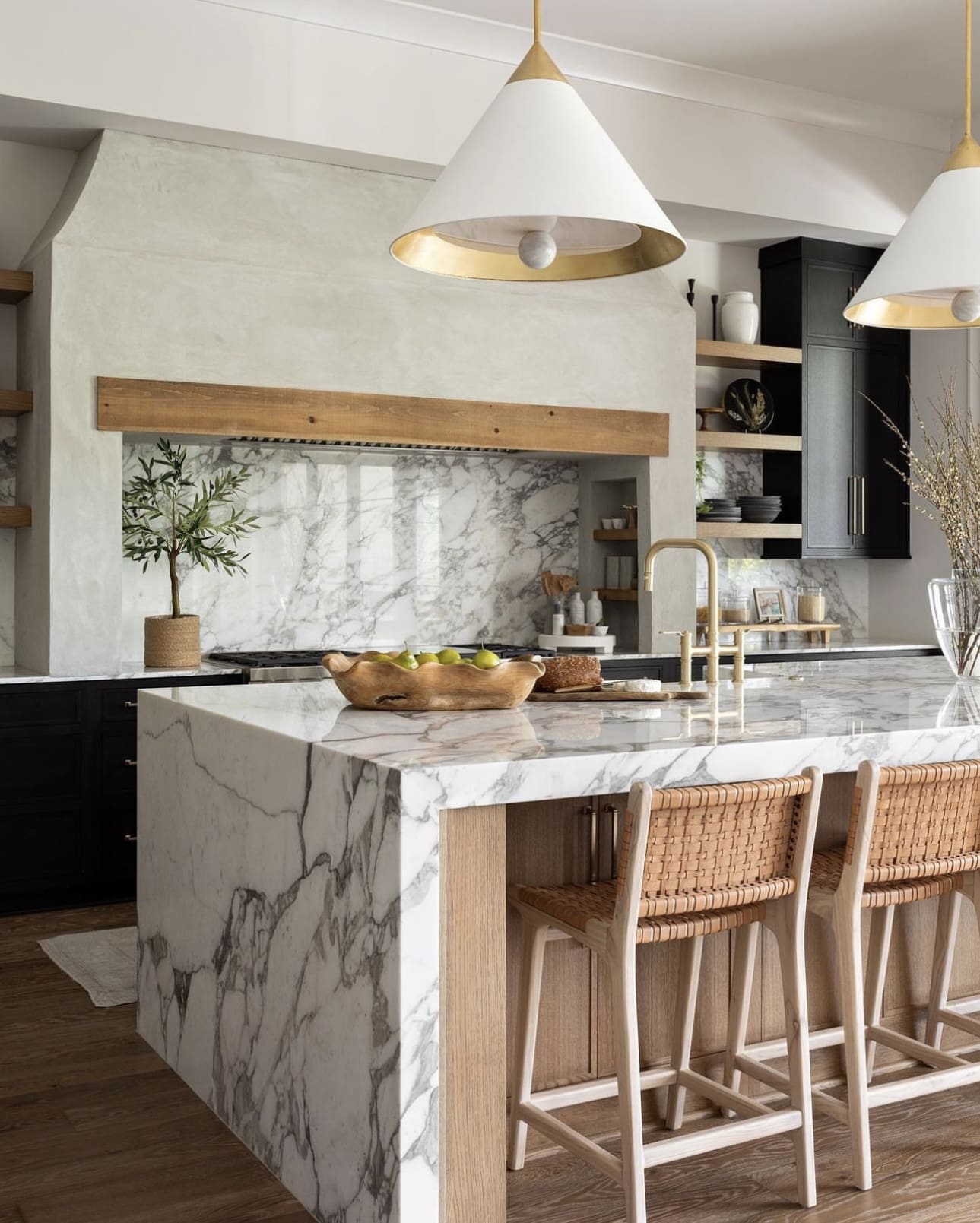 Marble Waterfall Island With Wood Accents Creates a Luxe Focal Point