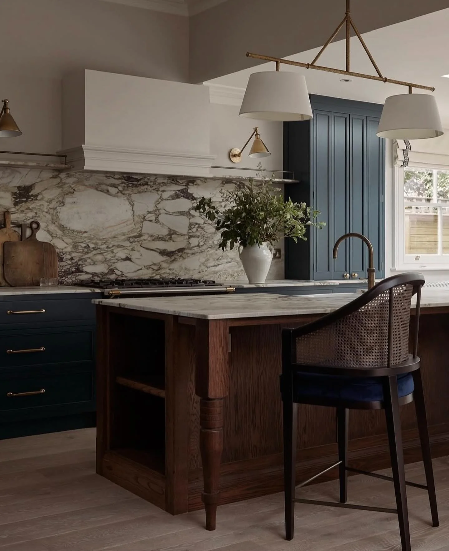 Dramatic Marble Slab Backsplash Behind Navy Cabinets