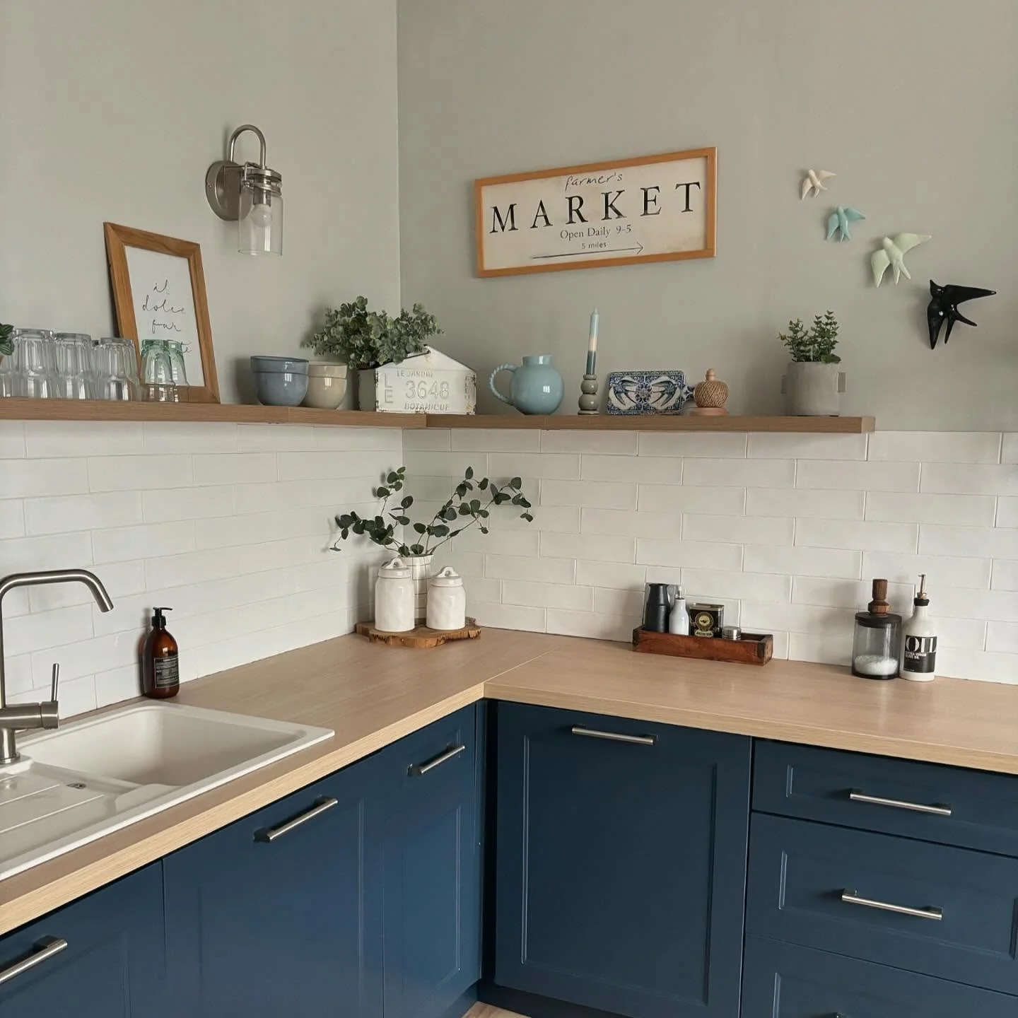 Ceramic Bird Wall Art Adds Whimsical Touch to Navy Kitchen
