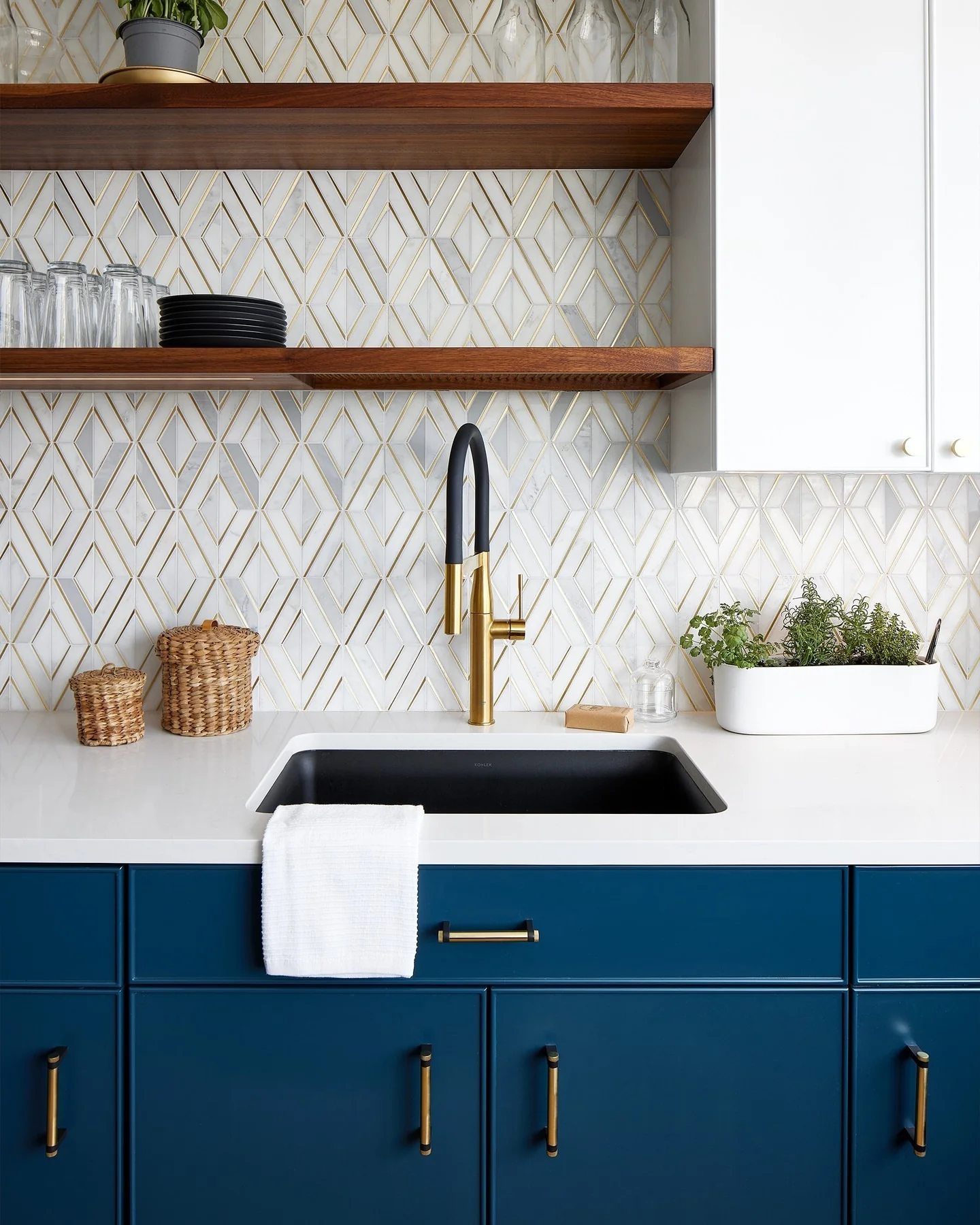Introduce Glamour with a Geometric Marble and Gold Backsplash