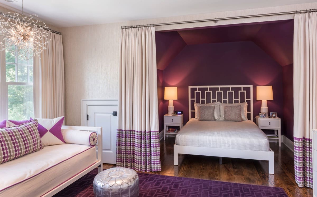 Deep Plum Walls Frame a White Geometric Headboard