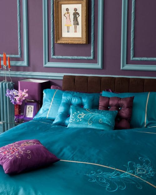Deep Purple Walls Complement Teal Bedding with Peacock Feather Accents