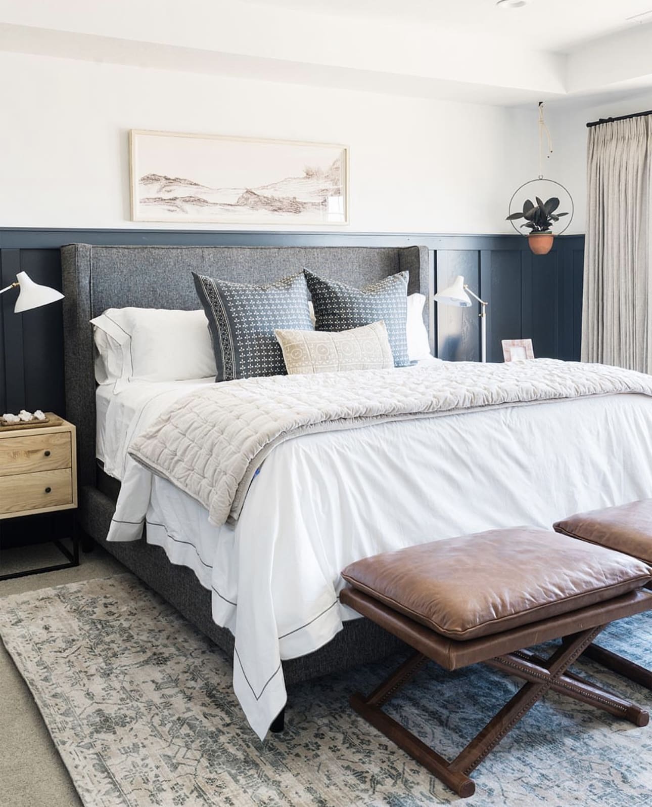 Framed Landscape Art Above Dark Paneled Headboard