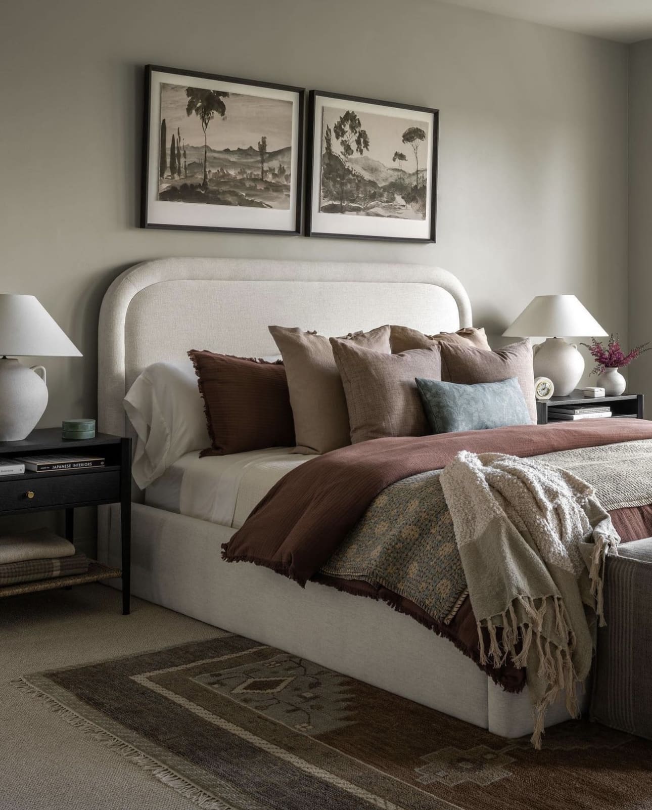 Pair Landscape Art Above an Upholstered Headboard