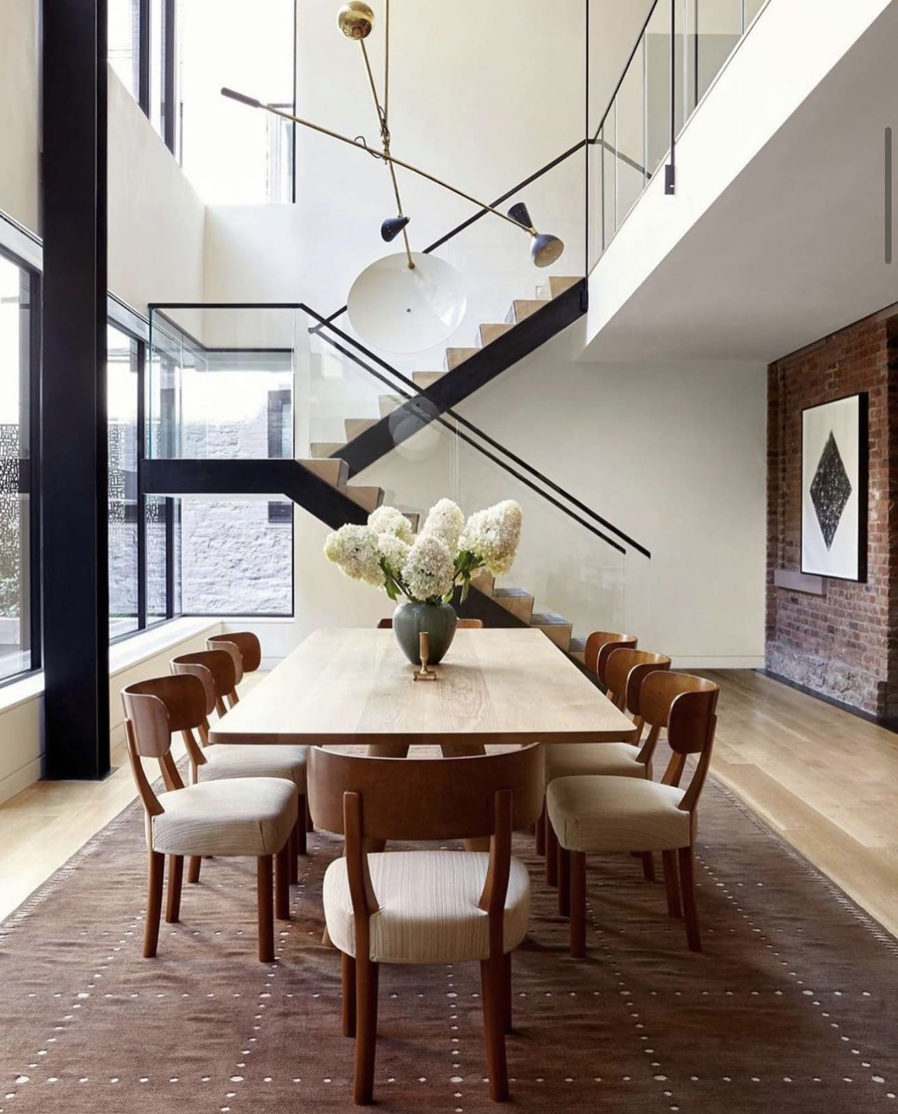 Light Wood Dining Table Anchored by a Textured Rug