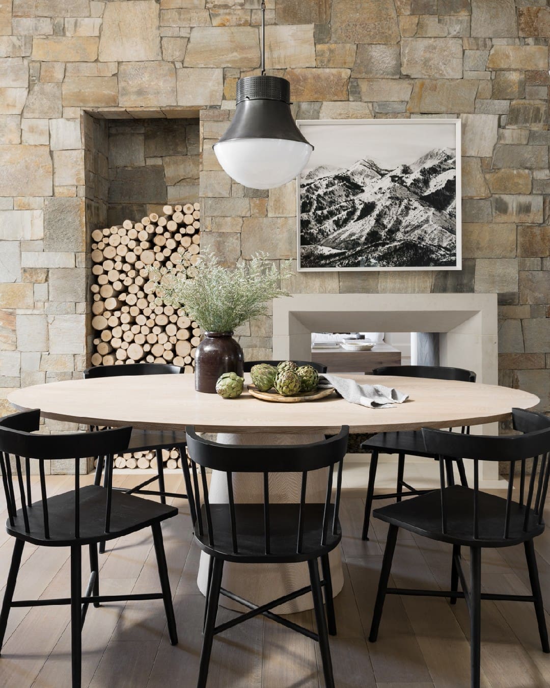 Black Spindle-Back Chairs Define the Oval Dining Table