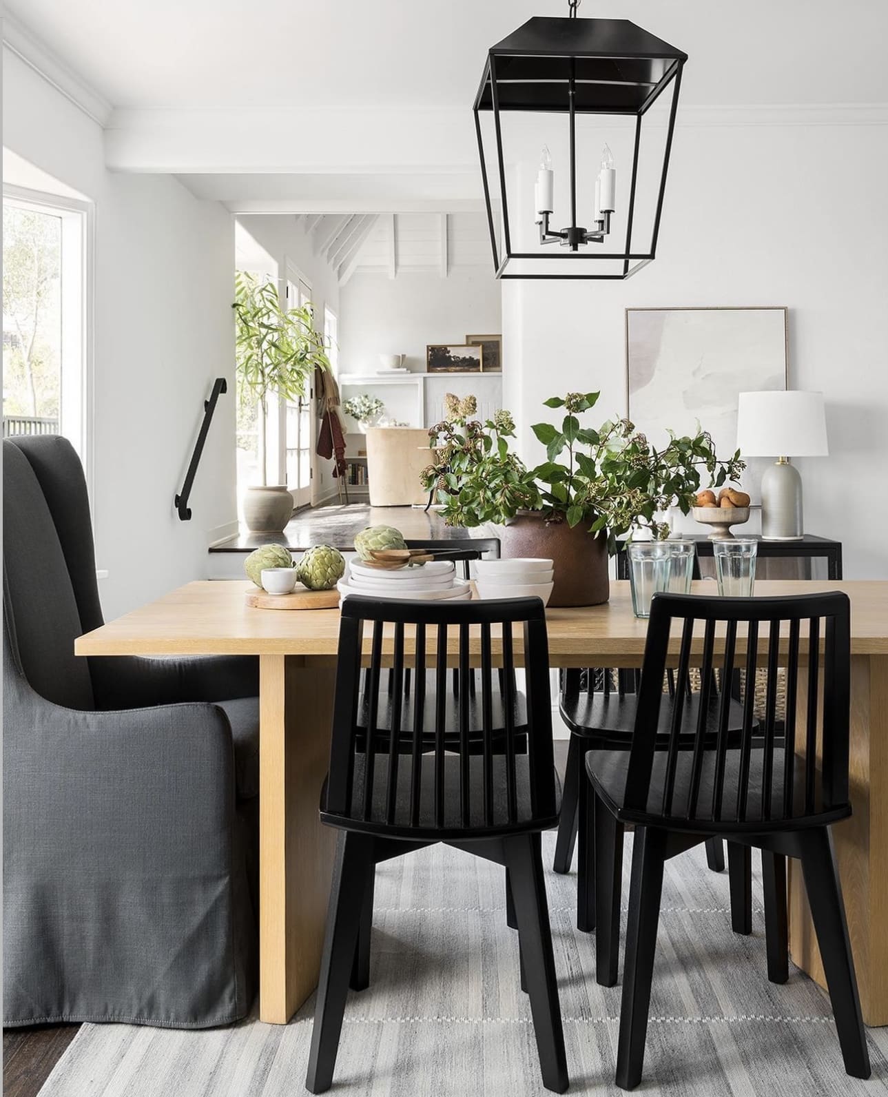 Black Spindle Chairs Add Graphic Contrast to a Light Wood Table