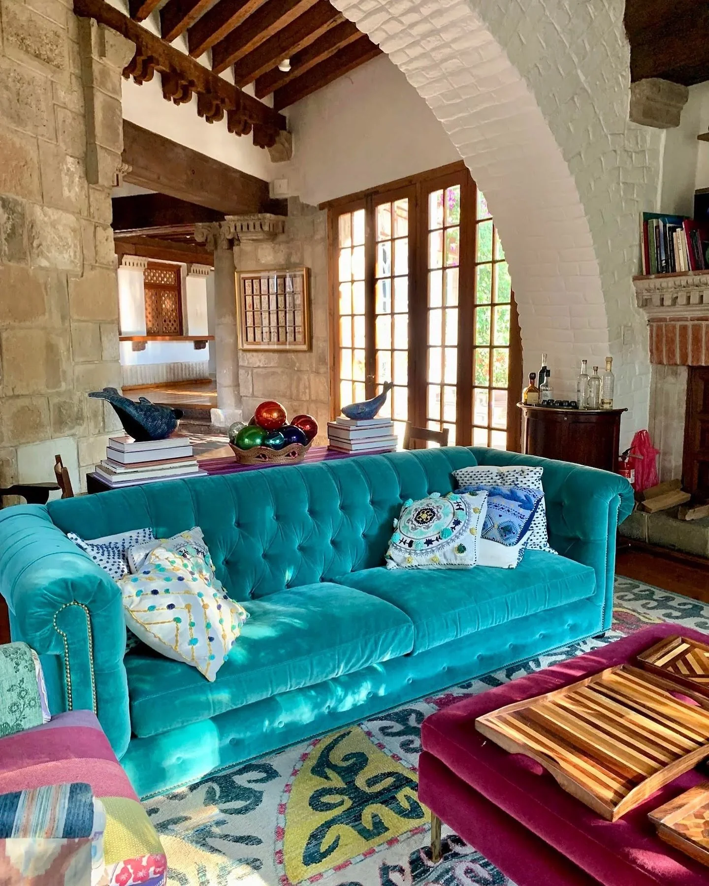 Tufted Turquoise Sofa With Eclectic Patterned Pillows