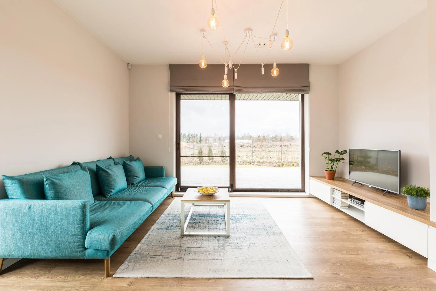 Turquoise Sofa Anchors a Light and Airy Living Space