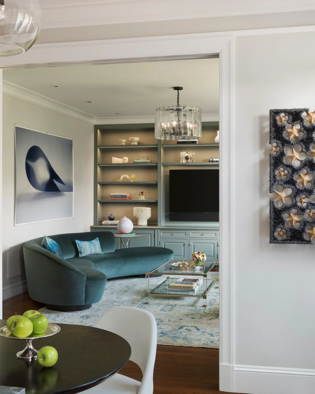 Curved Turquoise Sofa With Matching Built-In Shelving