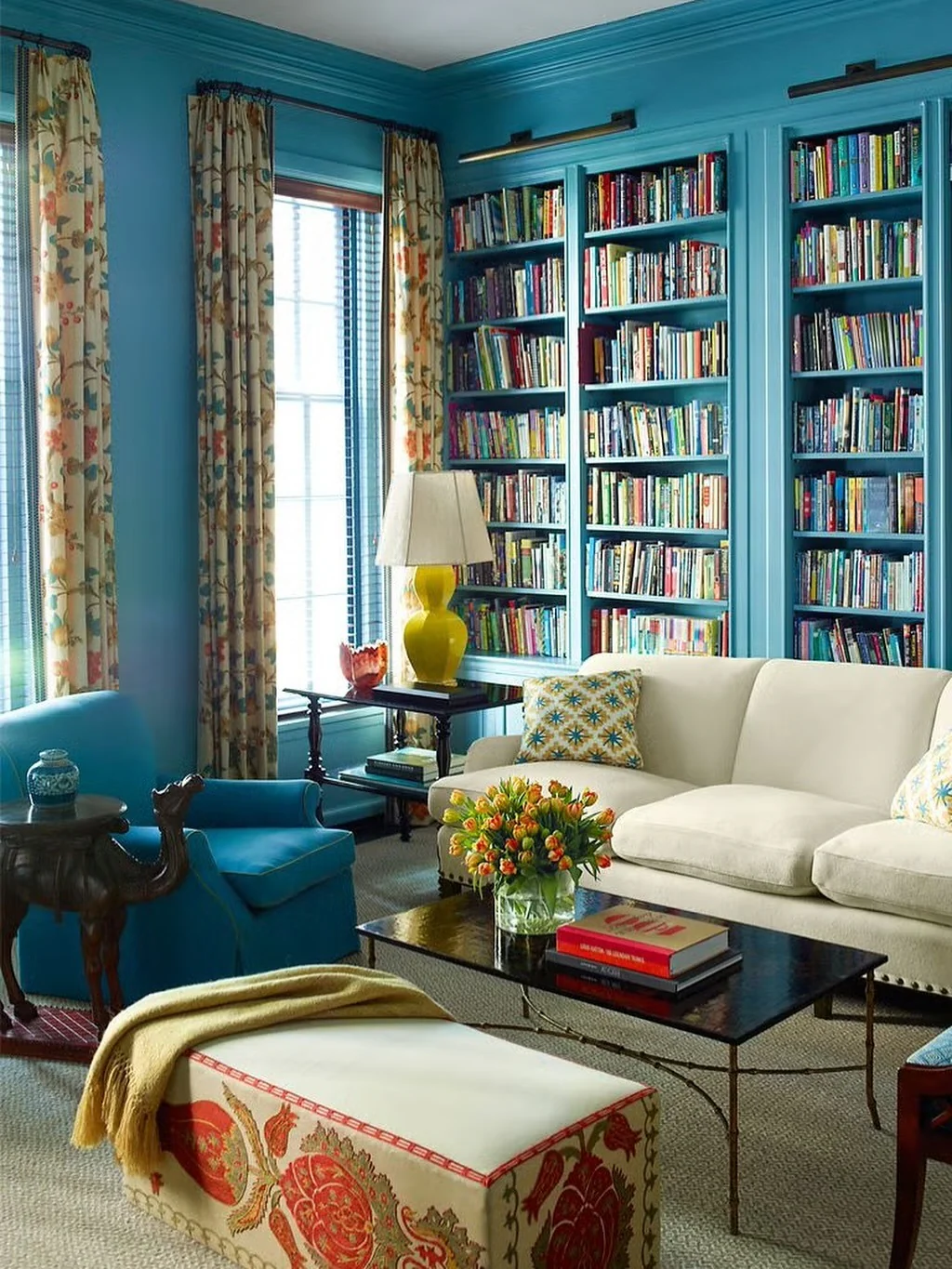 Turquoise Built-In Shelves Frame a Cream Sofa