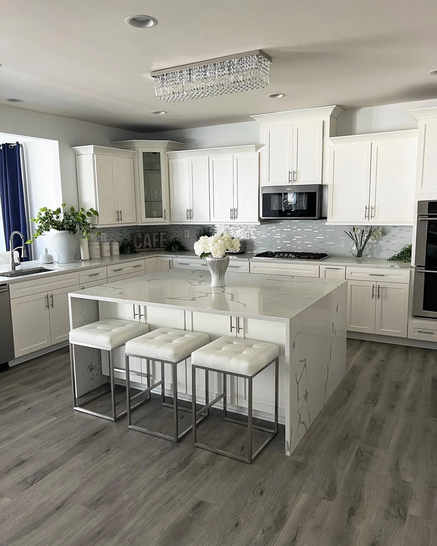 Crystal Chandelier Adds Glamour to White Kitchen Island