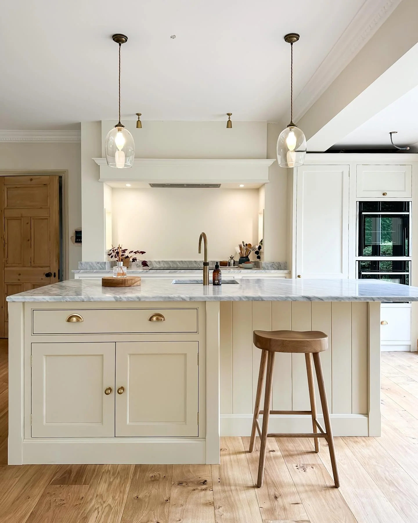 Soften Your Island with Creamy Cabinets and Curved Hardware