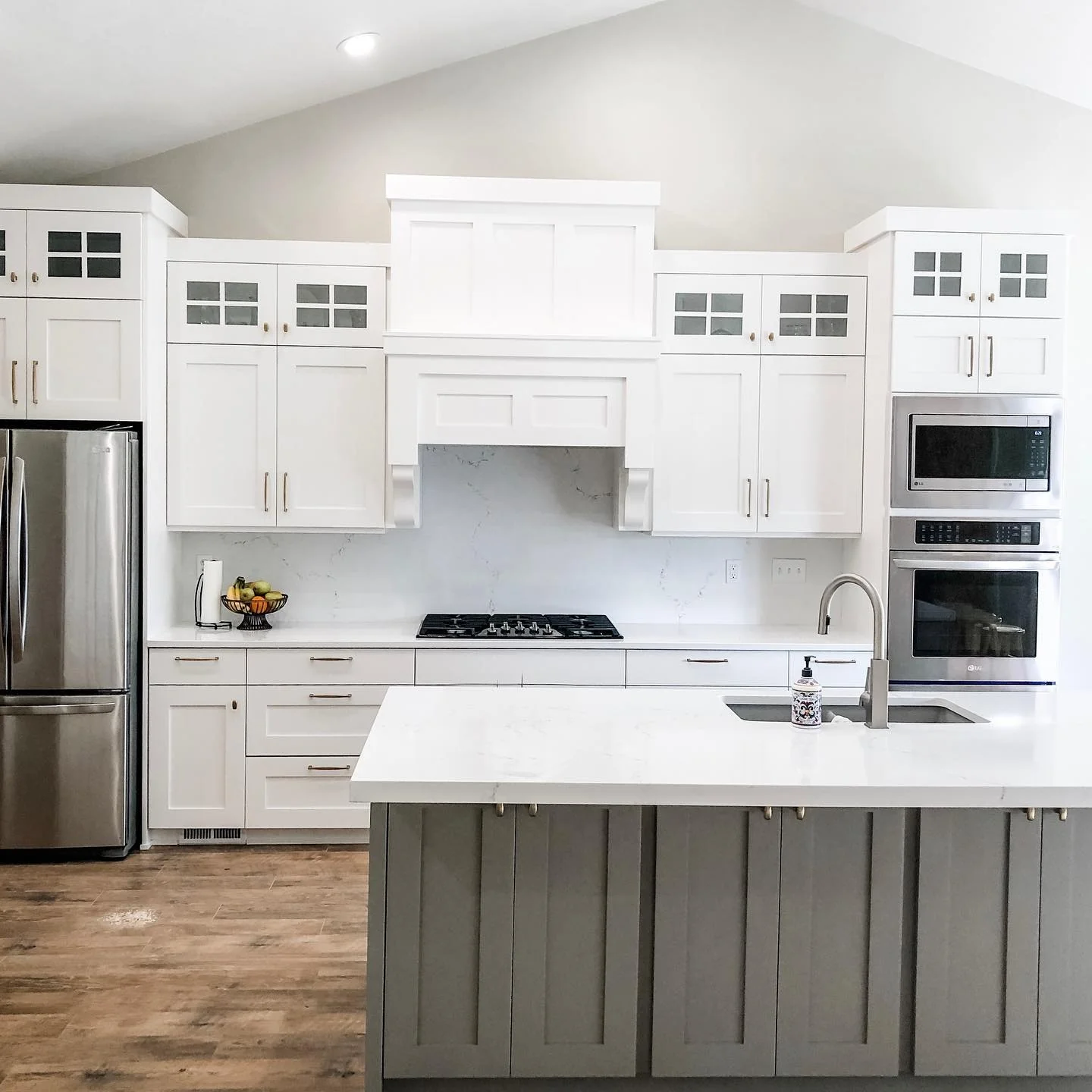 Subtle Shine with Gray Island Cabinets and Gold Pulls