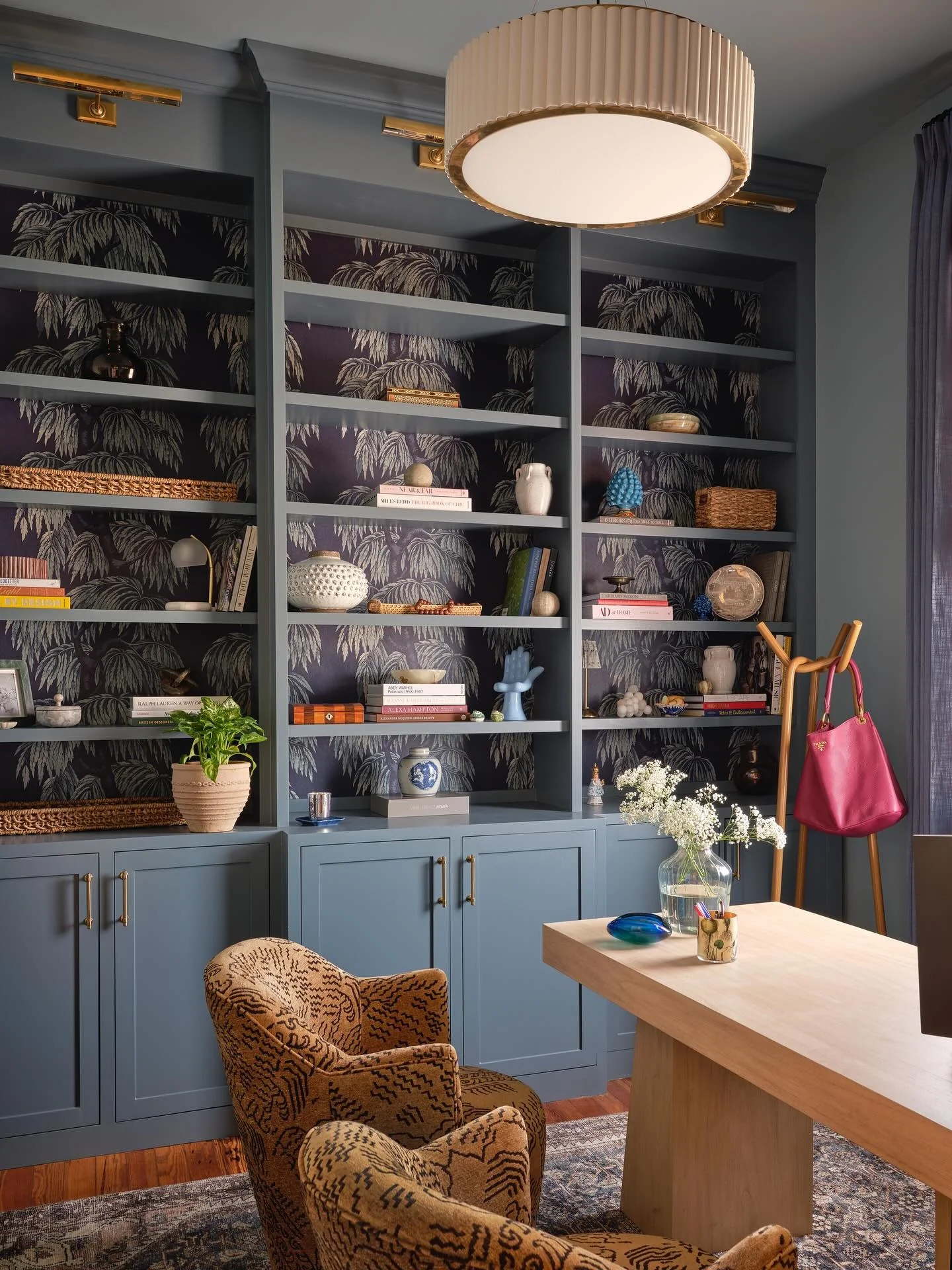 Patterned Wallpaper Adds Depth Behind Attic Office Shelves