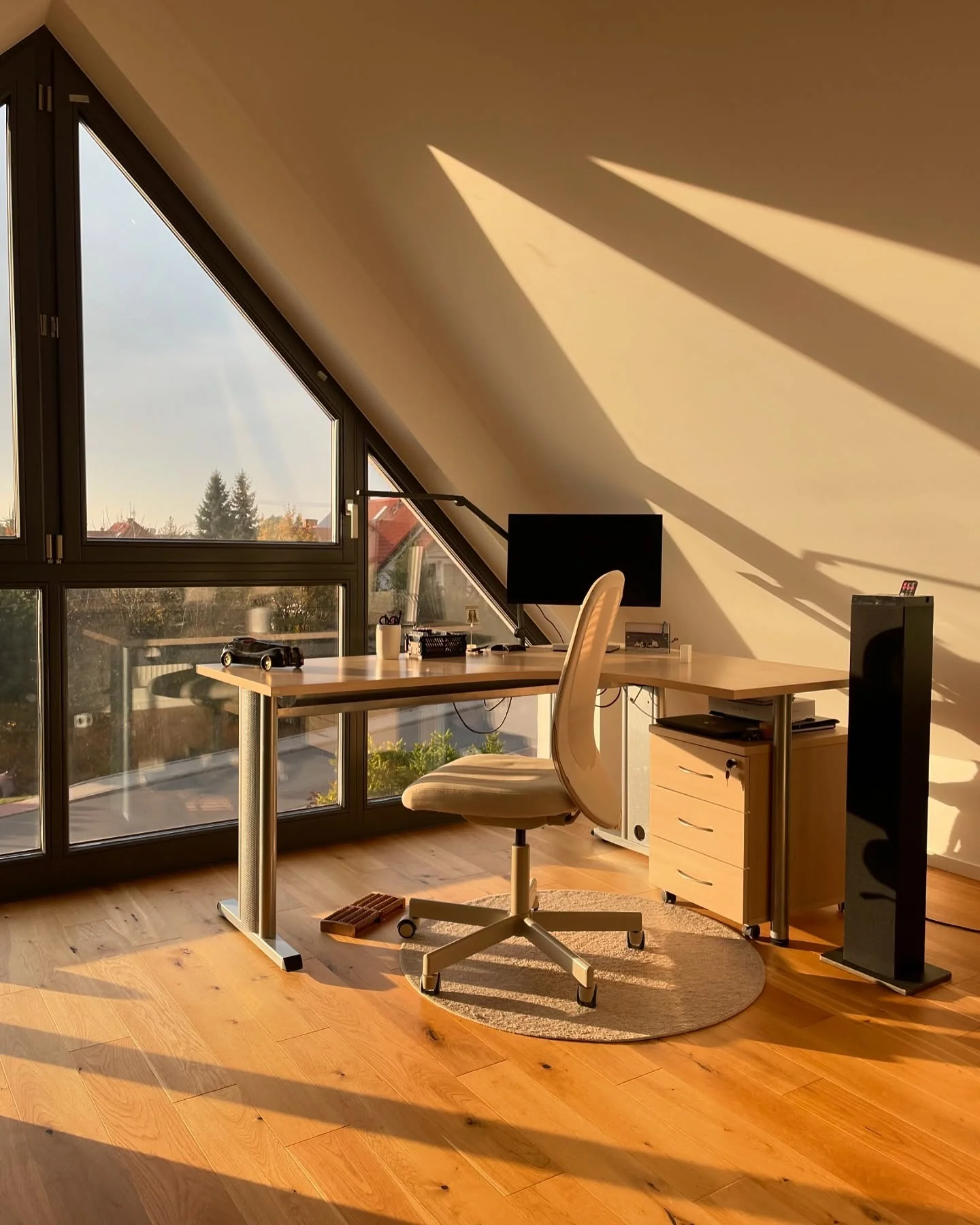 Angled Attic Window Frames a Sunlit Workspace