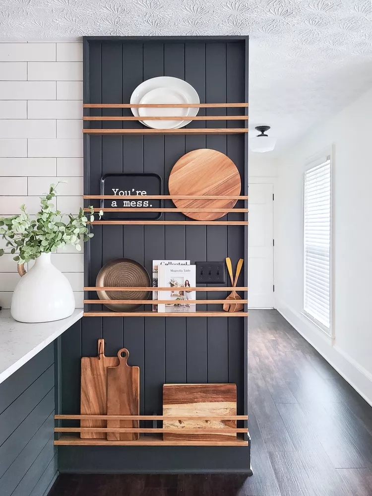 Wooden Shelves With Slatted Fronts Hold Cutting Boards