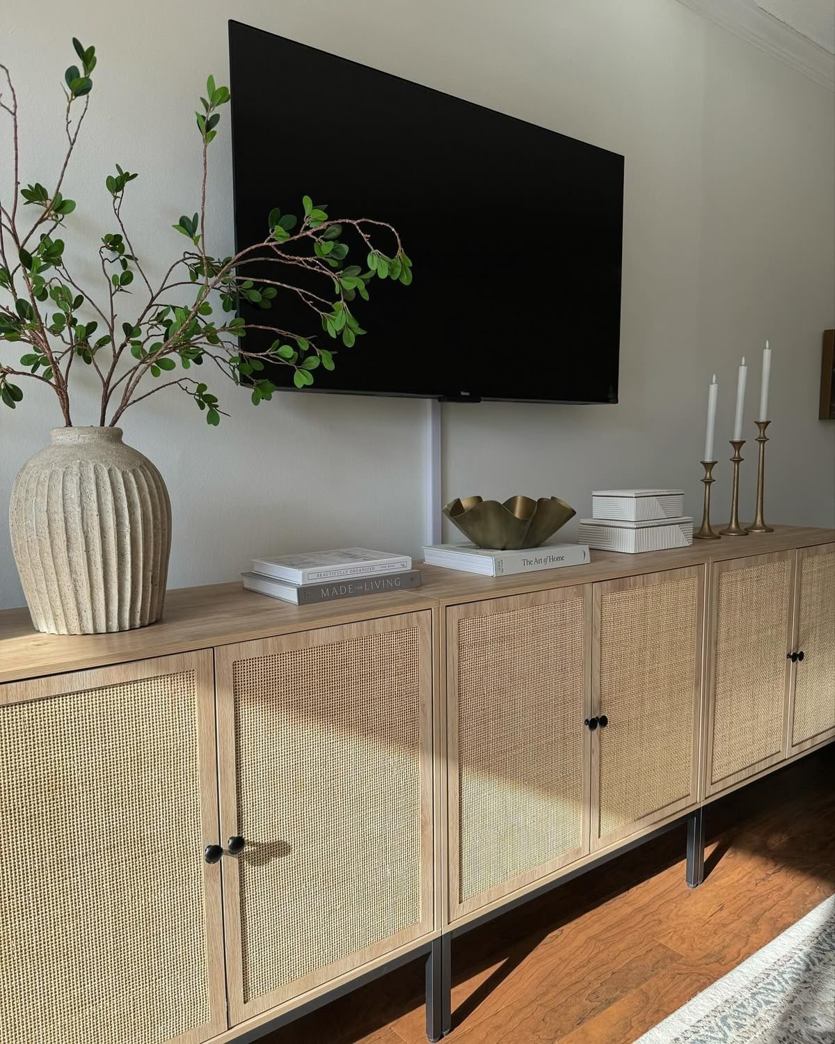 Ribbed Ceramic Vase Holds Organic Branches Near TV