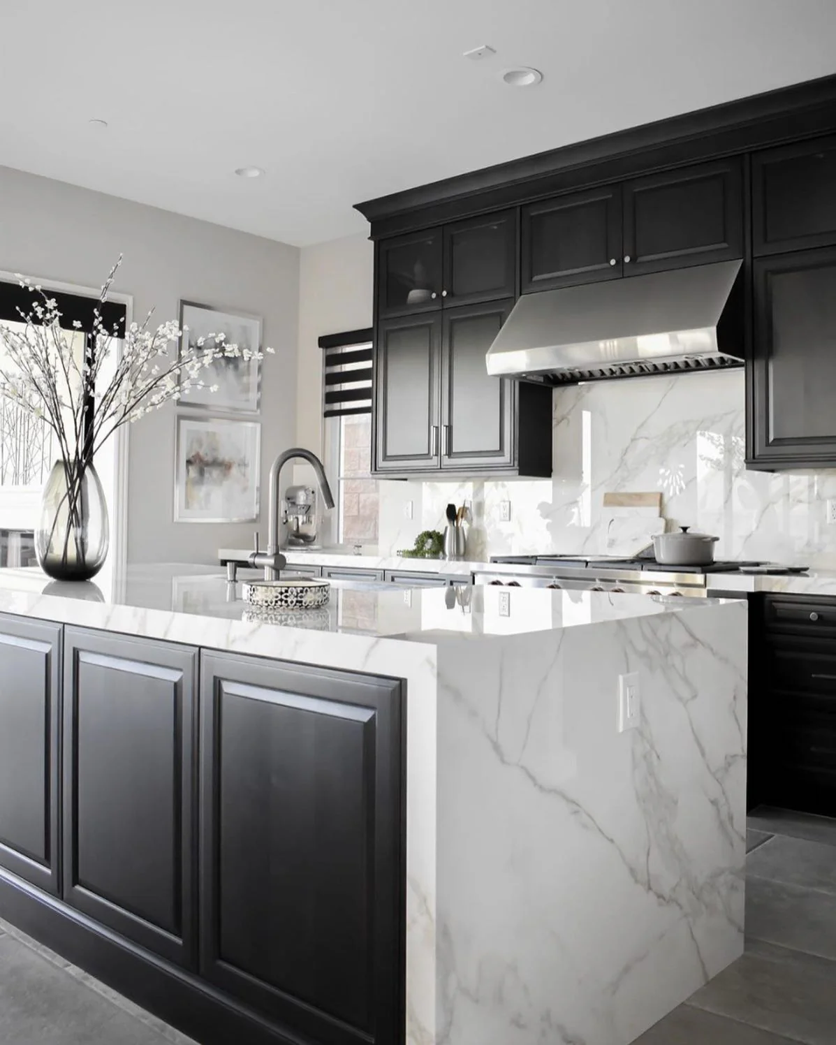 Marble Waterfall Island Meets Dark Cabinetry