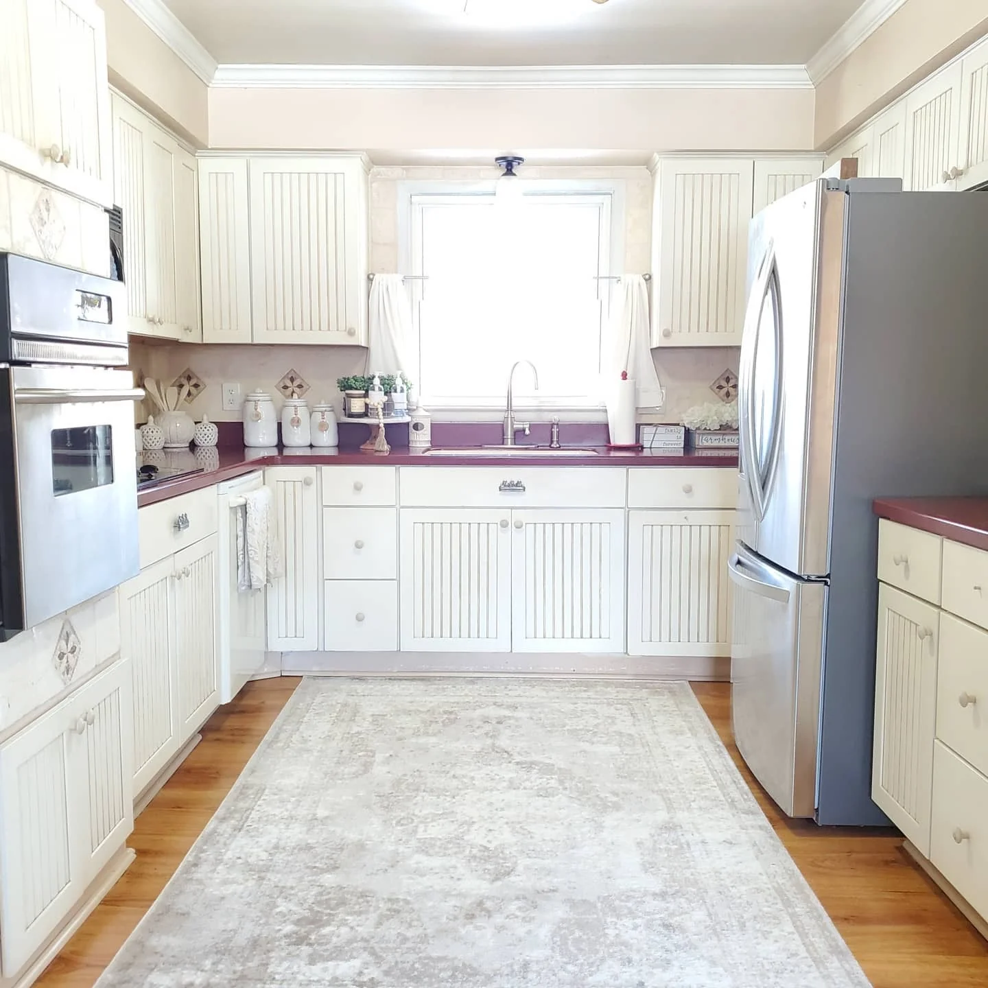 Cream Beadboard Cabinets Frame a Windowed Sink Area