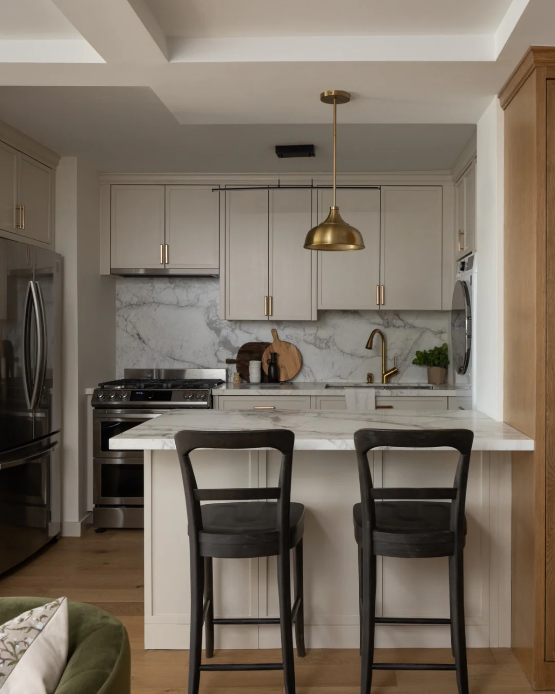 Brass Bell Pendant Light Adds Warm Glow Above Island