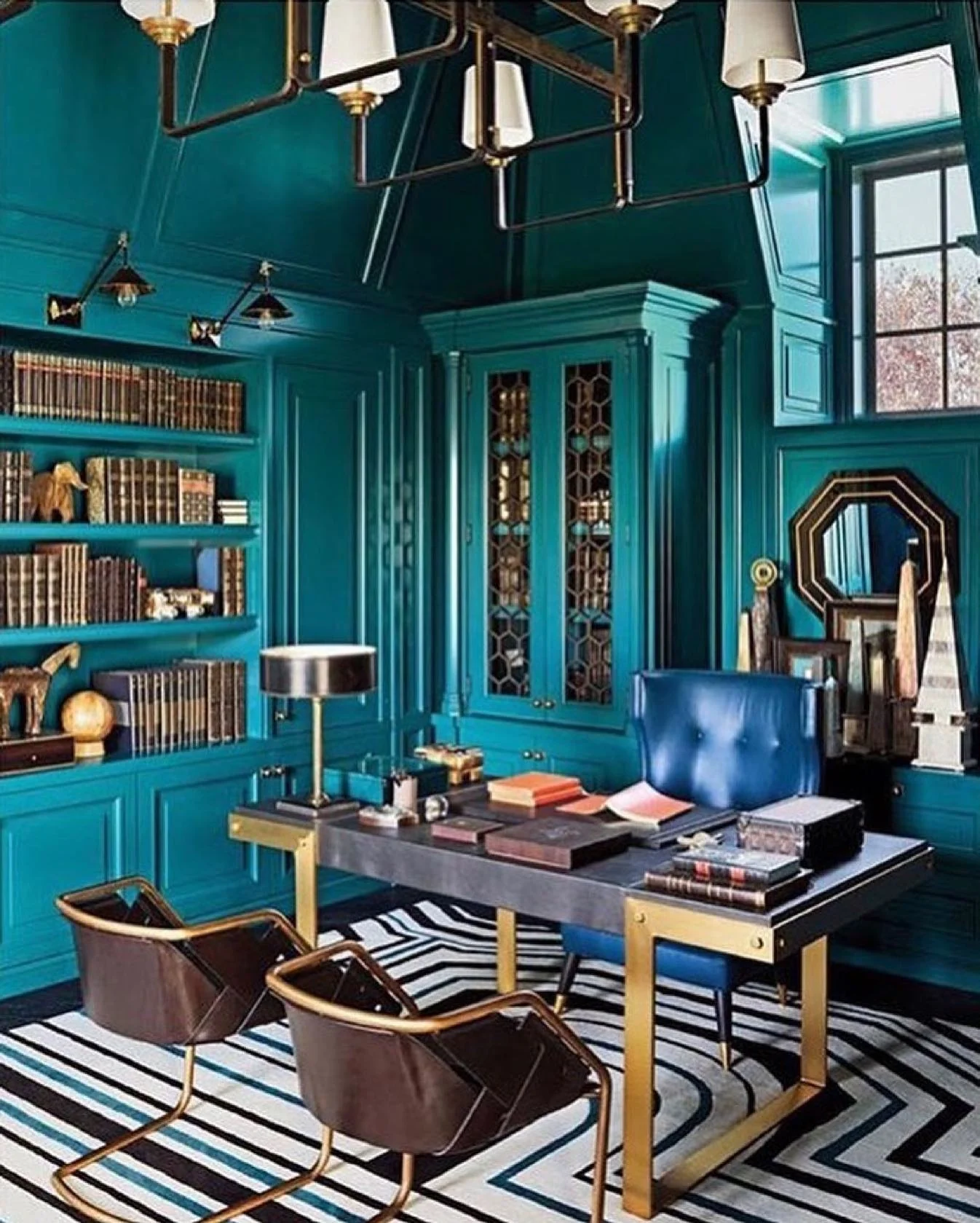 Geometric Patterned Rug Anchors Teal Walls