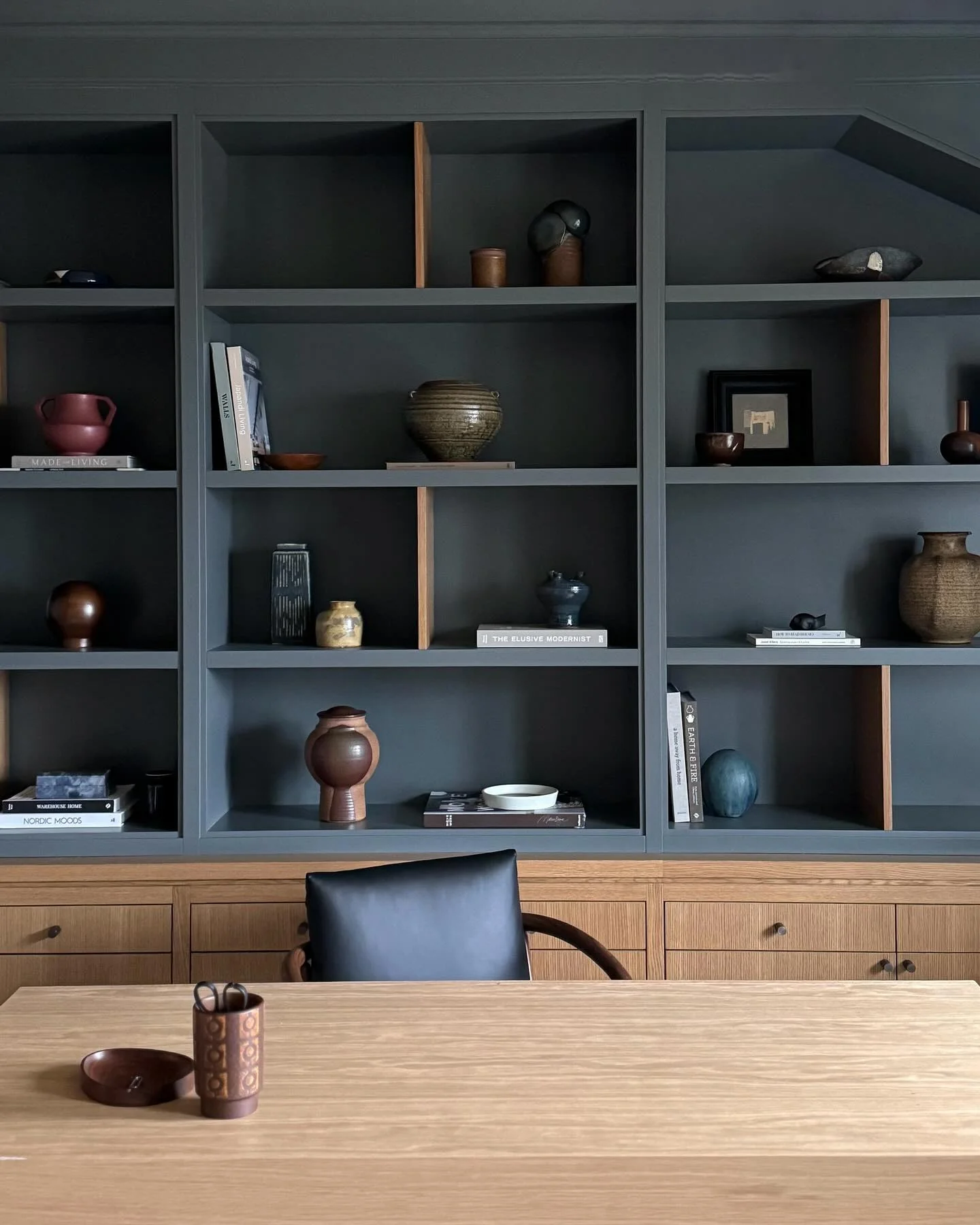 Dark Teal Shelving With Natural Wood Accents