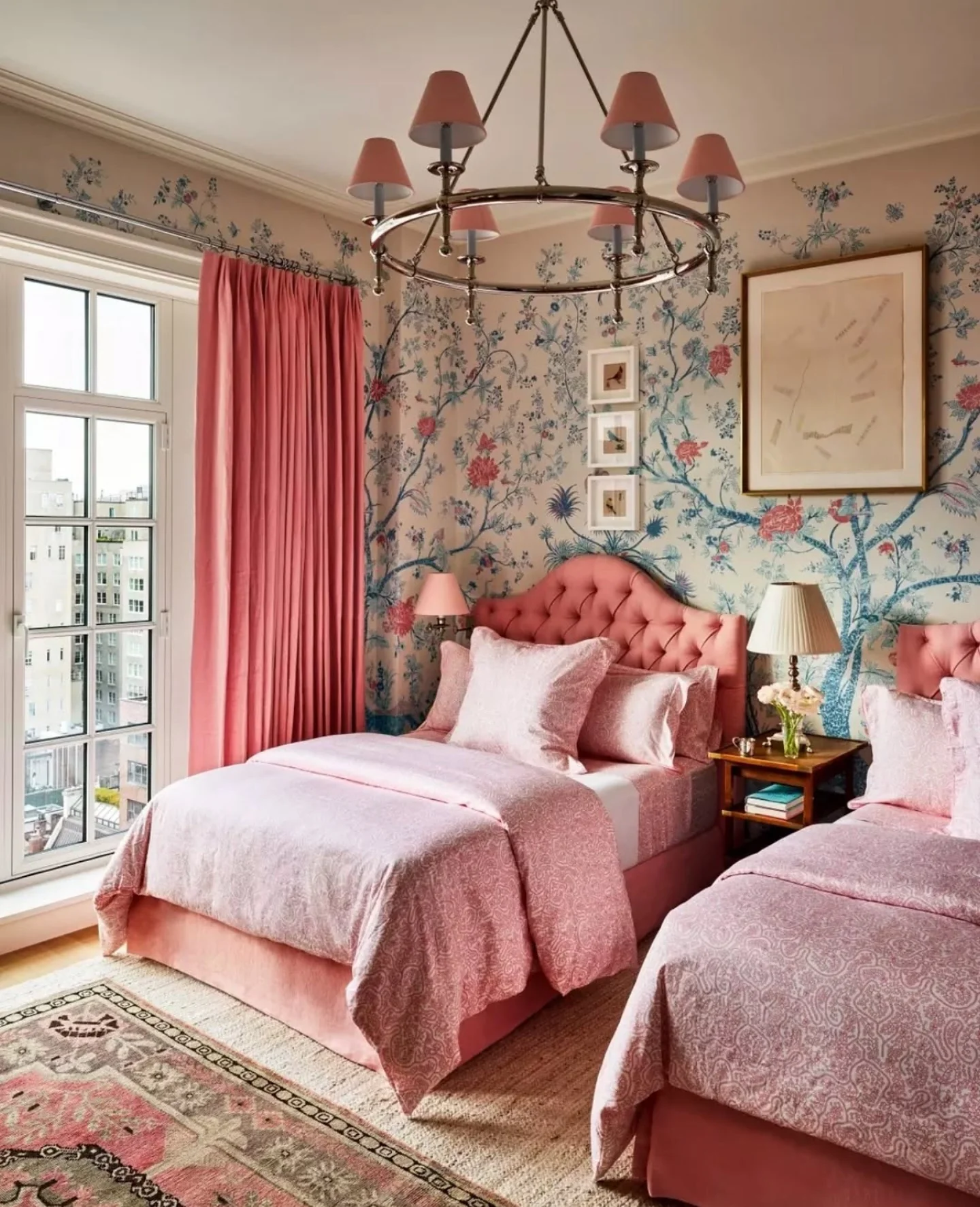 Pink floral wallpaper sets a romantic mood for twin beds