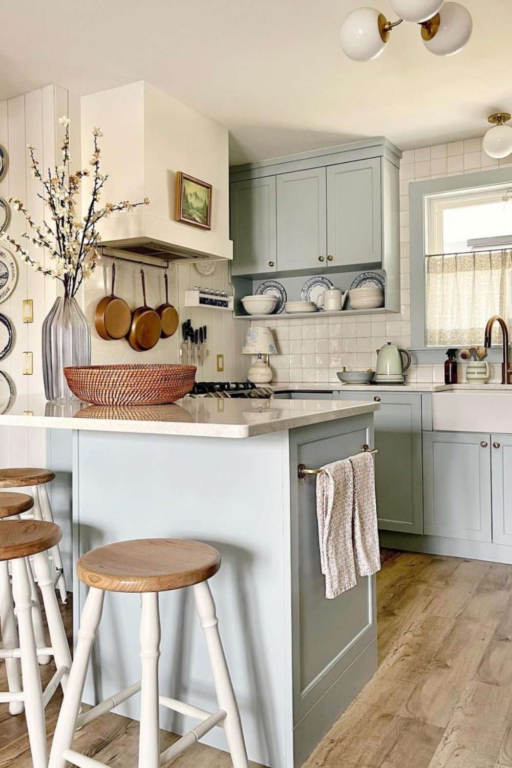 Soft Blue Cabinets with White Accents Create a Serene Kitchen