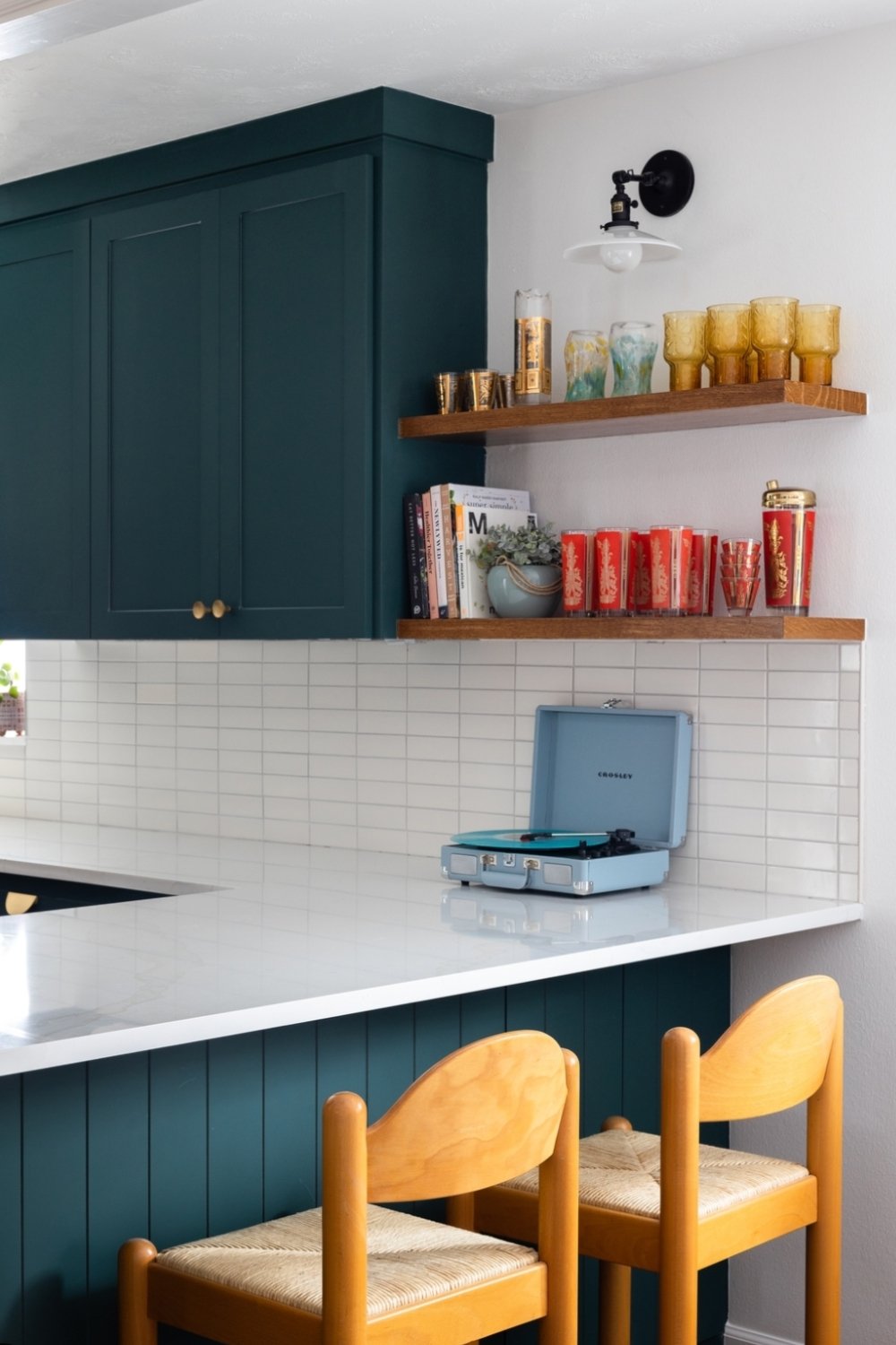 Deep Teal Cabinets with Brass Knobs Create a Moody Kitchen