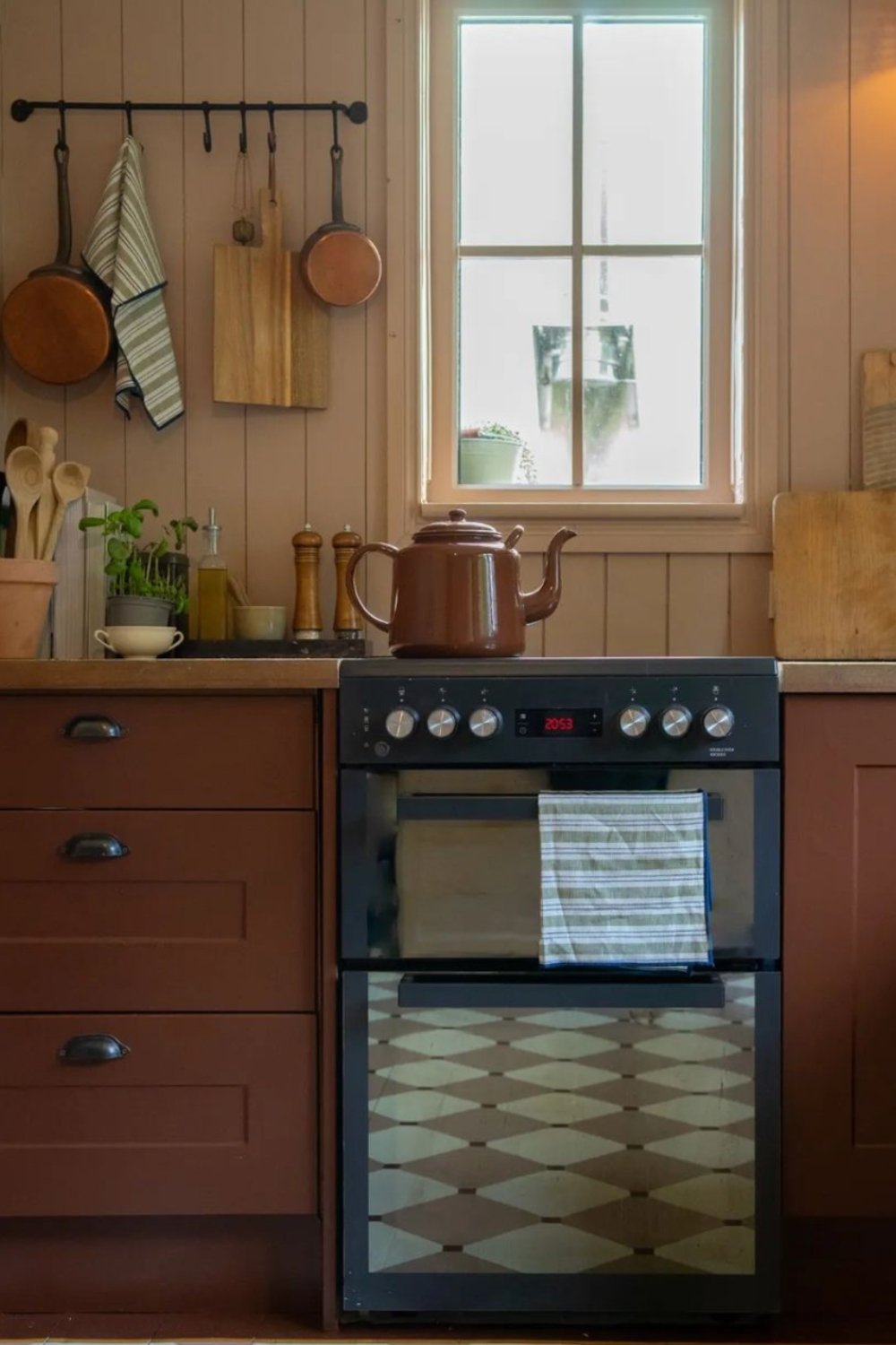 Deep Reddish-Brown Cabinets with Black Cup Pulls for a Classic Look