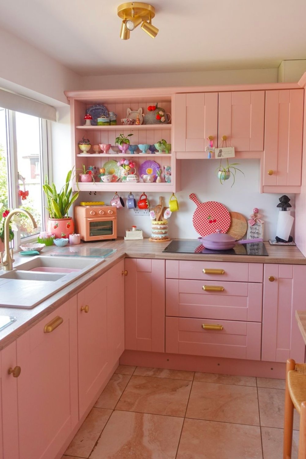 Soft Pink Cabinets with Gold Hardware for a Playful Space
