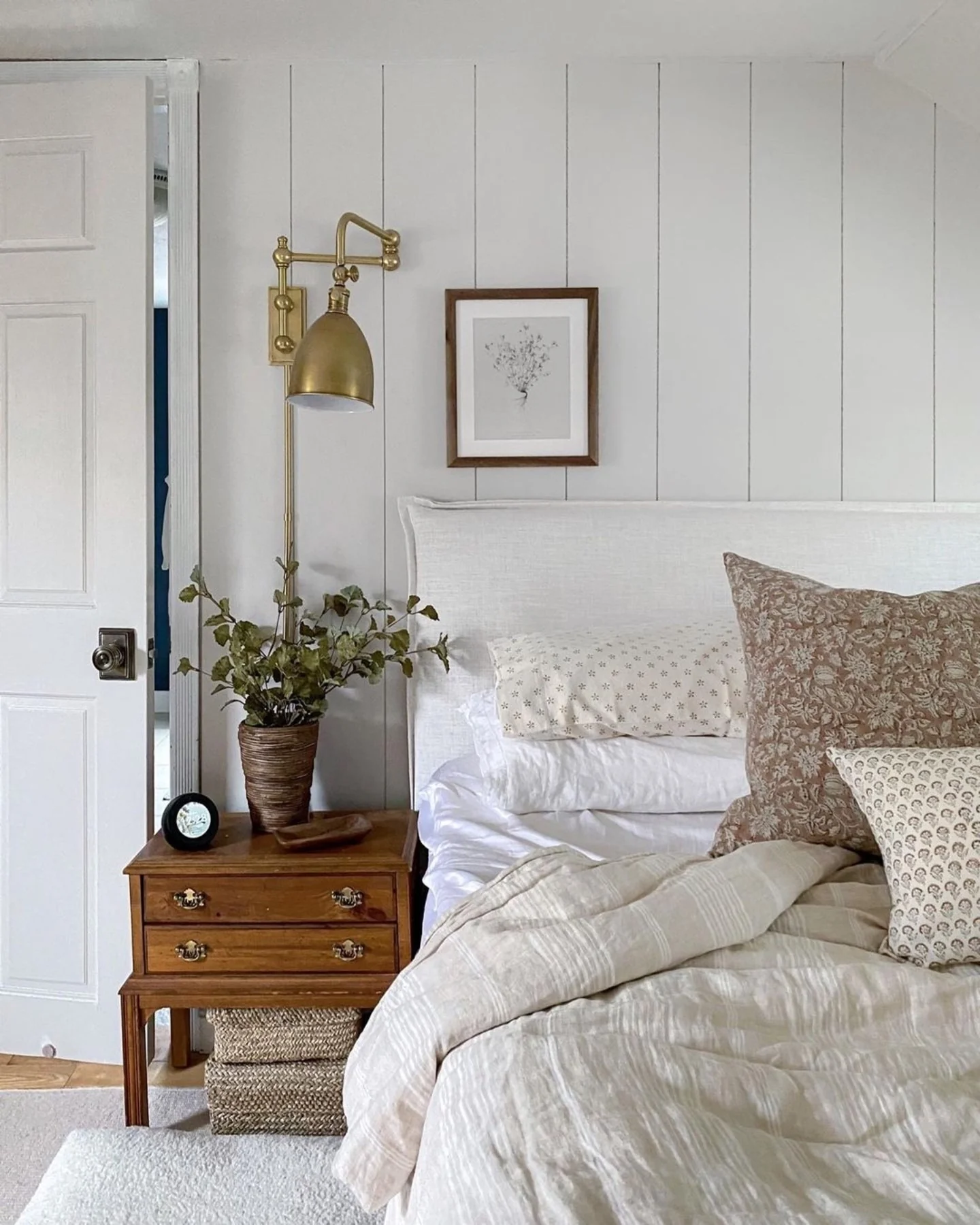 Adjustable Brass Sconce Adds Task Lighting Above Nightstand