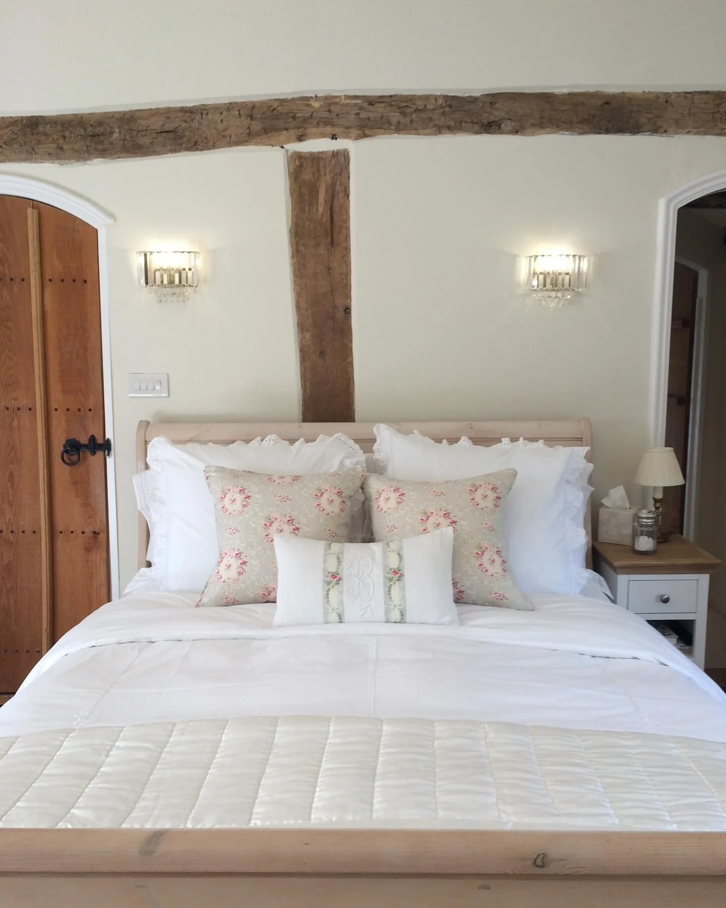 Crystal Sconces Add Glamour Above Exposed Wood Beams