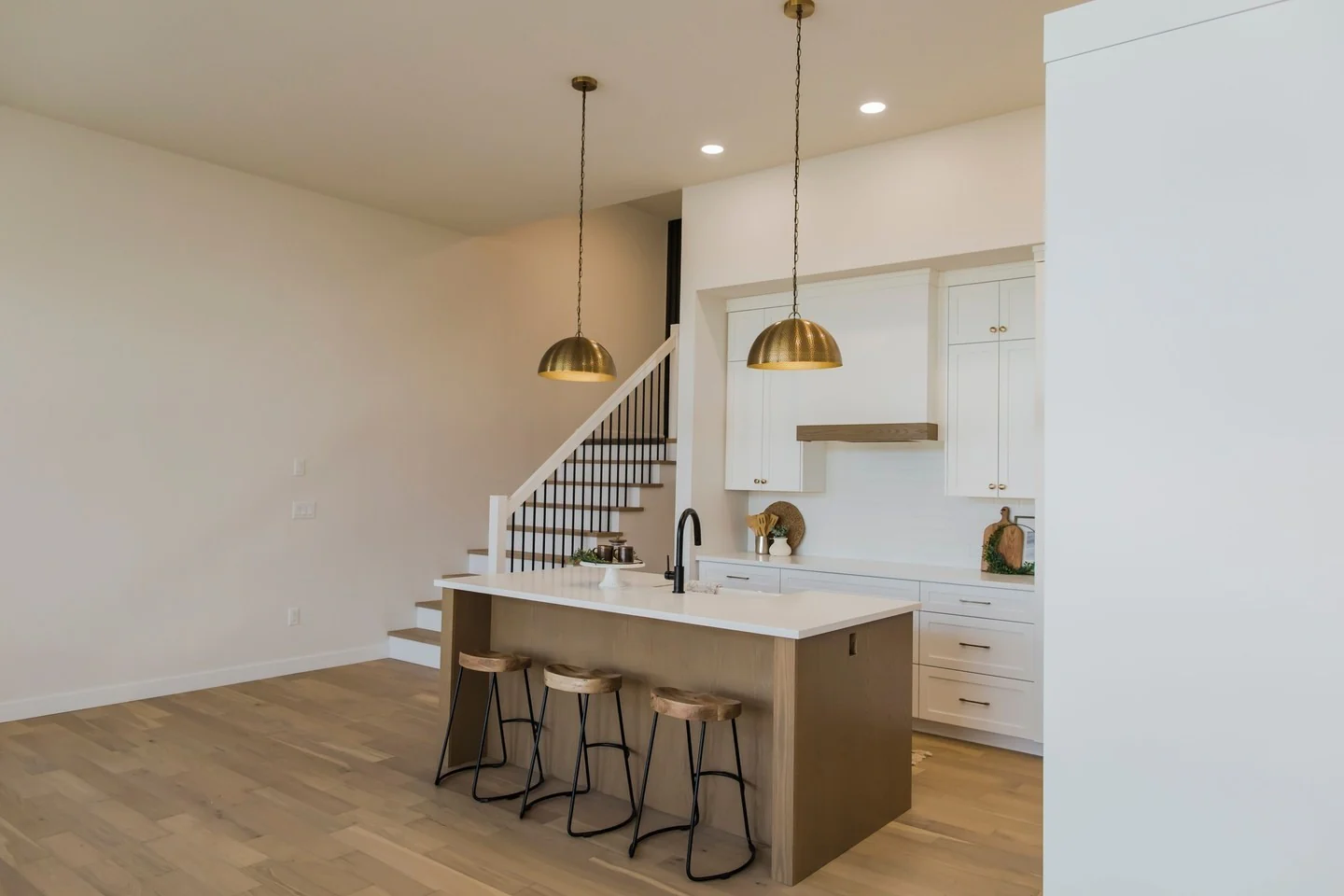 Brass dome pendants cast a warm glow over the island