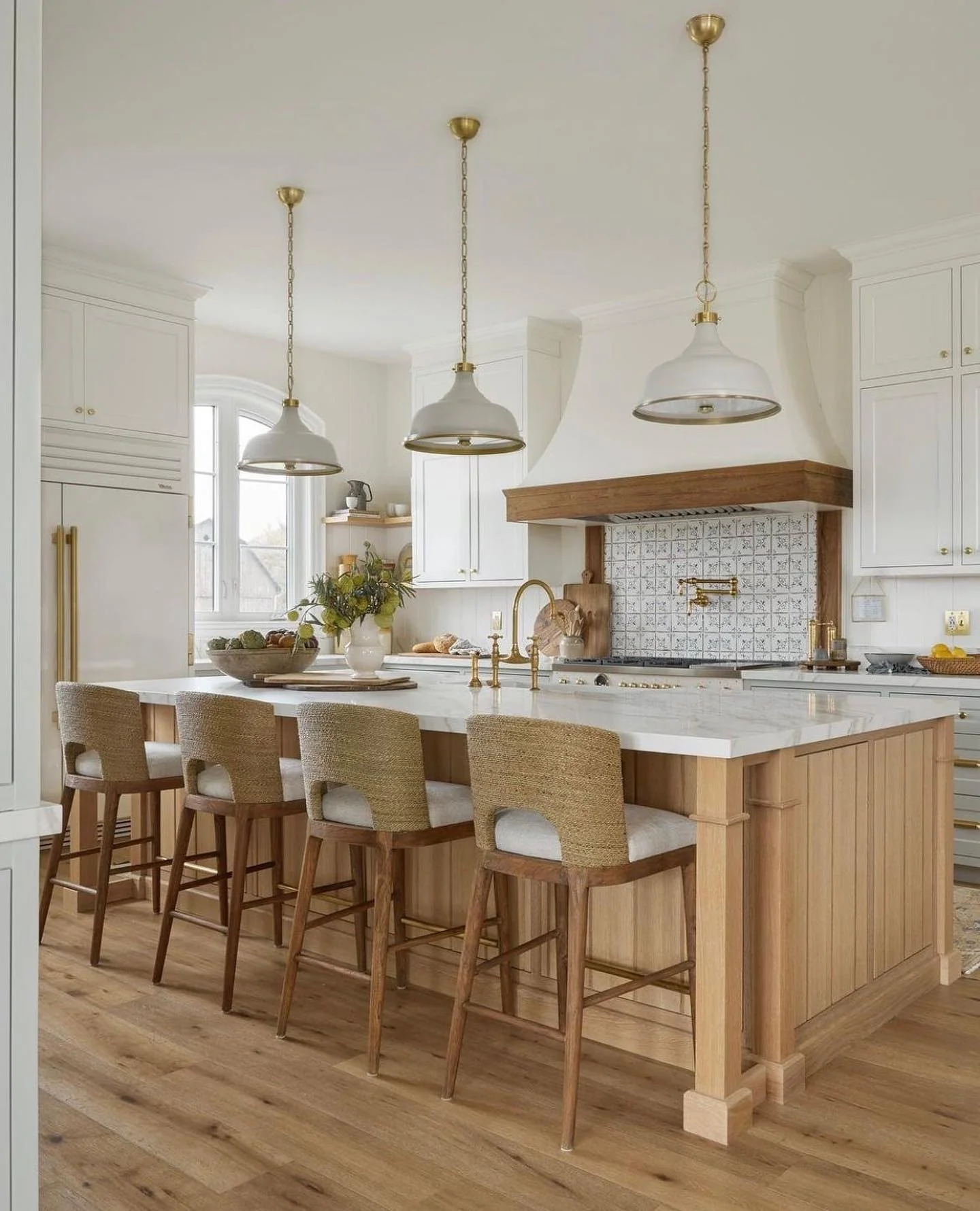 Wood-Paneled Island with Rattan-Back Stools Creates Cozy Seating