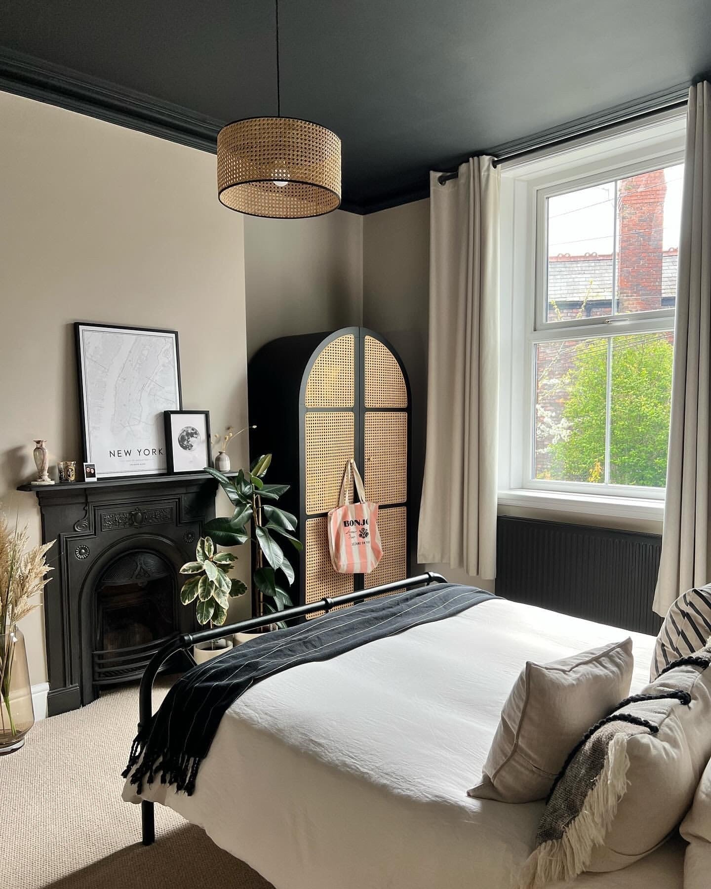Black Arch Wardrobe with Cane Doors Adds Natural Texture