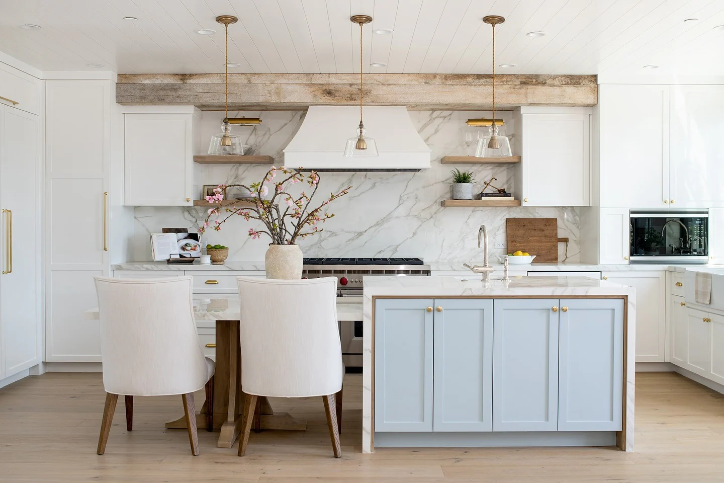 Marble-Patterned Backsplash Adds Depth Behind White Range