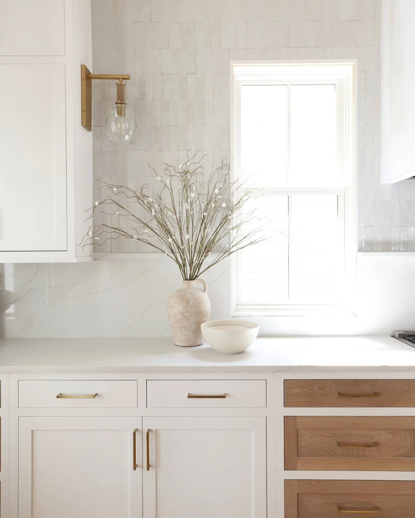 Stacked White Tiles Add Subtle Dimension Above the Counter